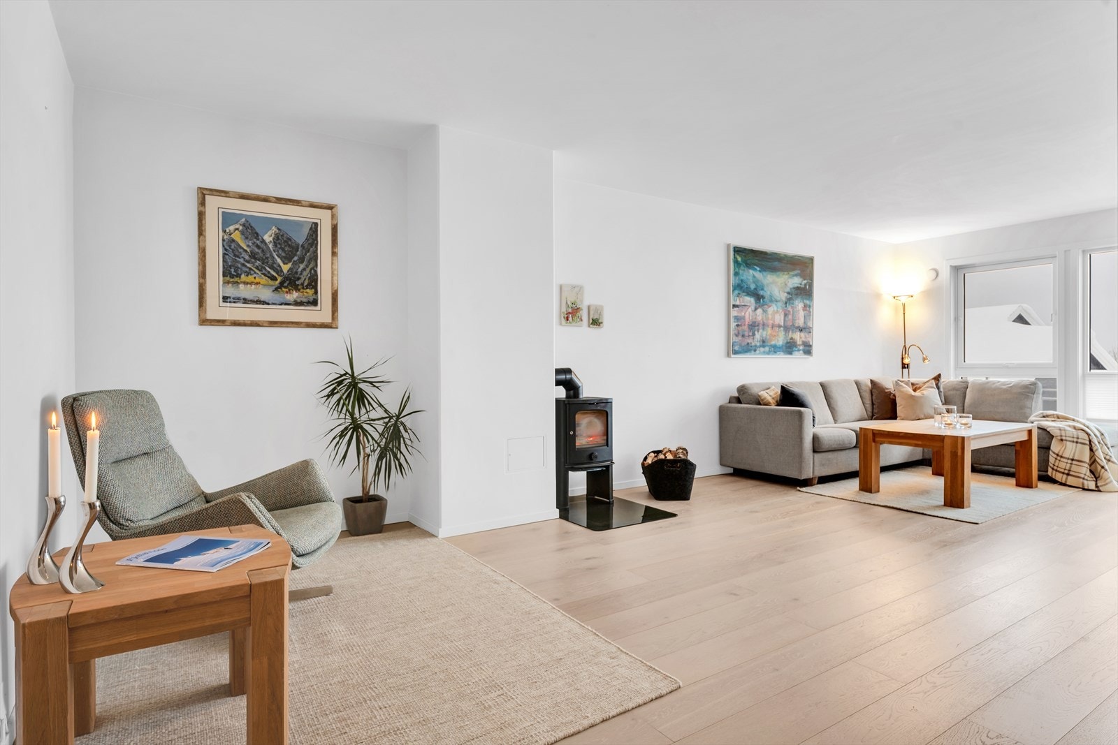 Innbydende og romslig stue med rikelig naturlig lysinnslipp fra store vindusflater, samt peis for kalde vinterdager eller som ekstra kveldskos. Galleribilde