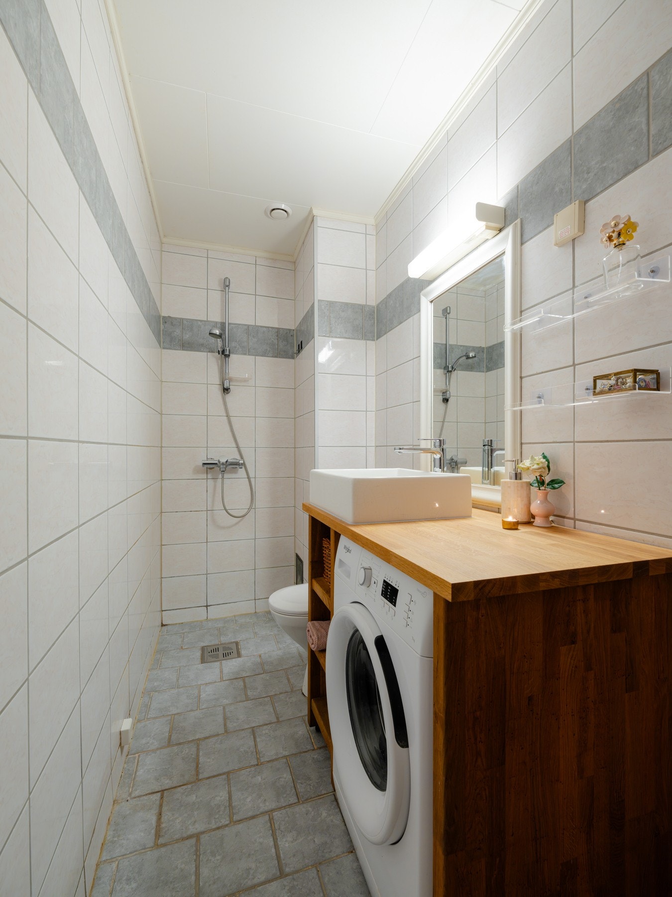 Boligens baderom er lyst, flislagt med varme i gulv. Badet har opplegg for vaskemaskin. Galleribilde