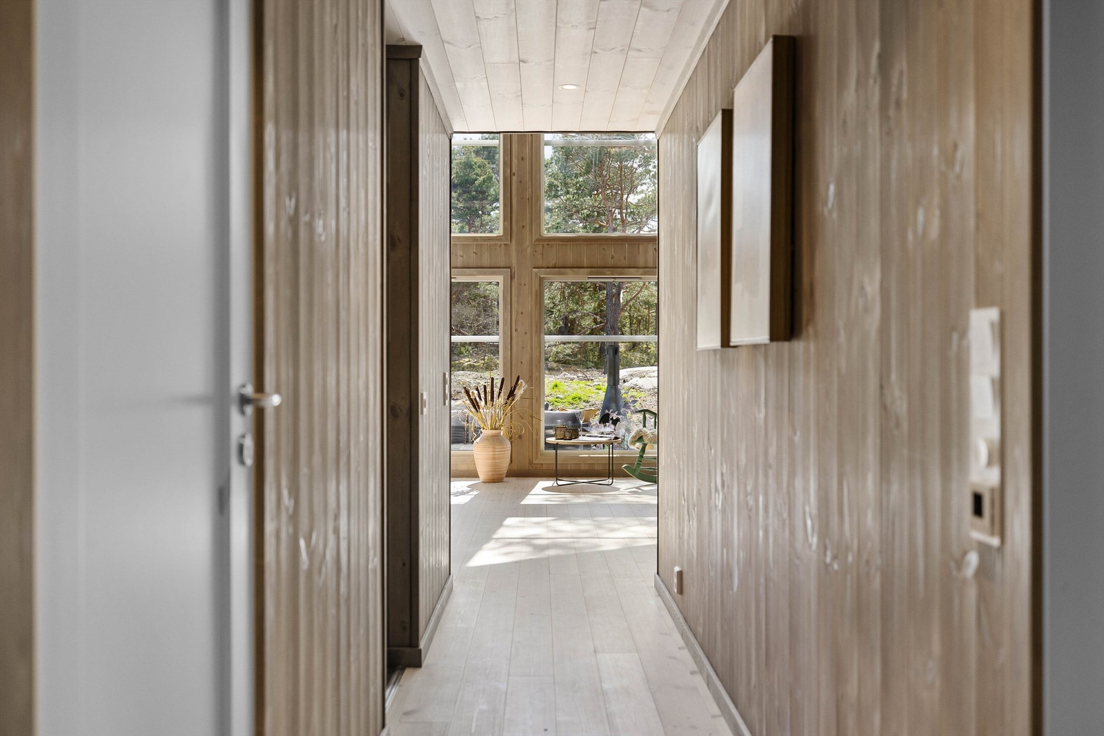 Stuens store vinduer slipper dagslys helt inn til gangen mellom soverommene. Galleribilde