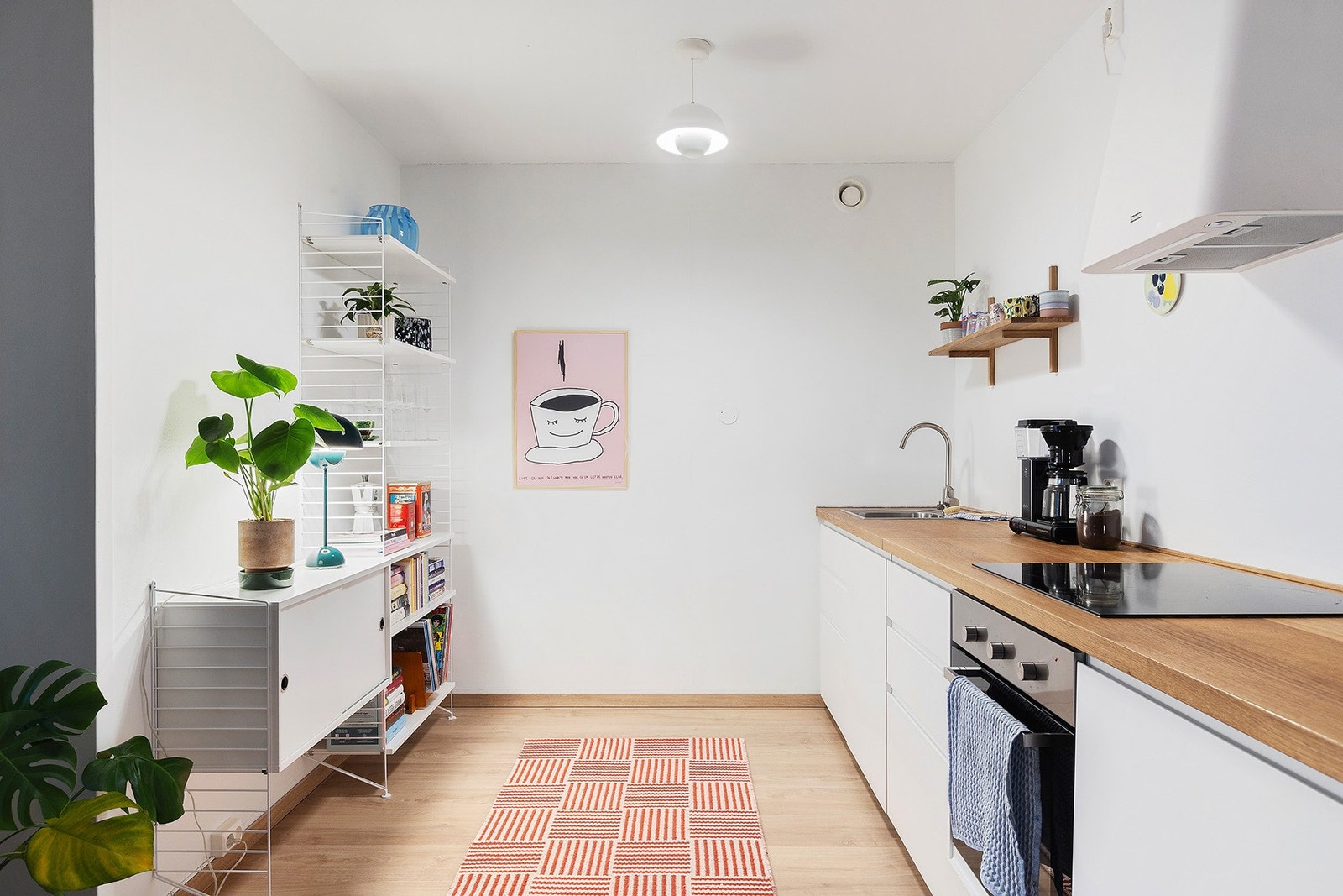 Kjøkkeninnredningen har glatte fronter med stekeovn, platetopp, kjøleskap og oppvaskmaskin alt integrert i innredningen. Galleribilde