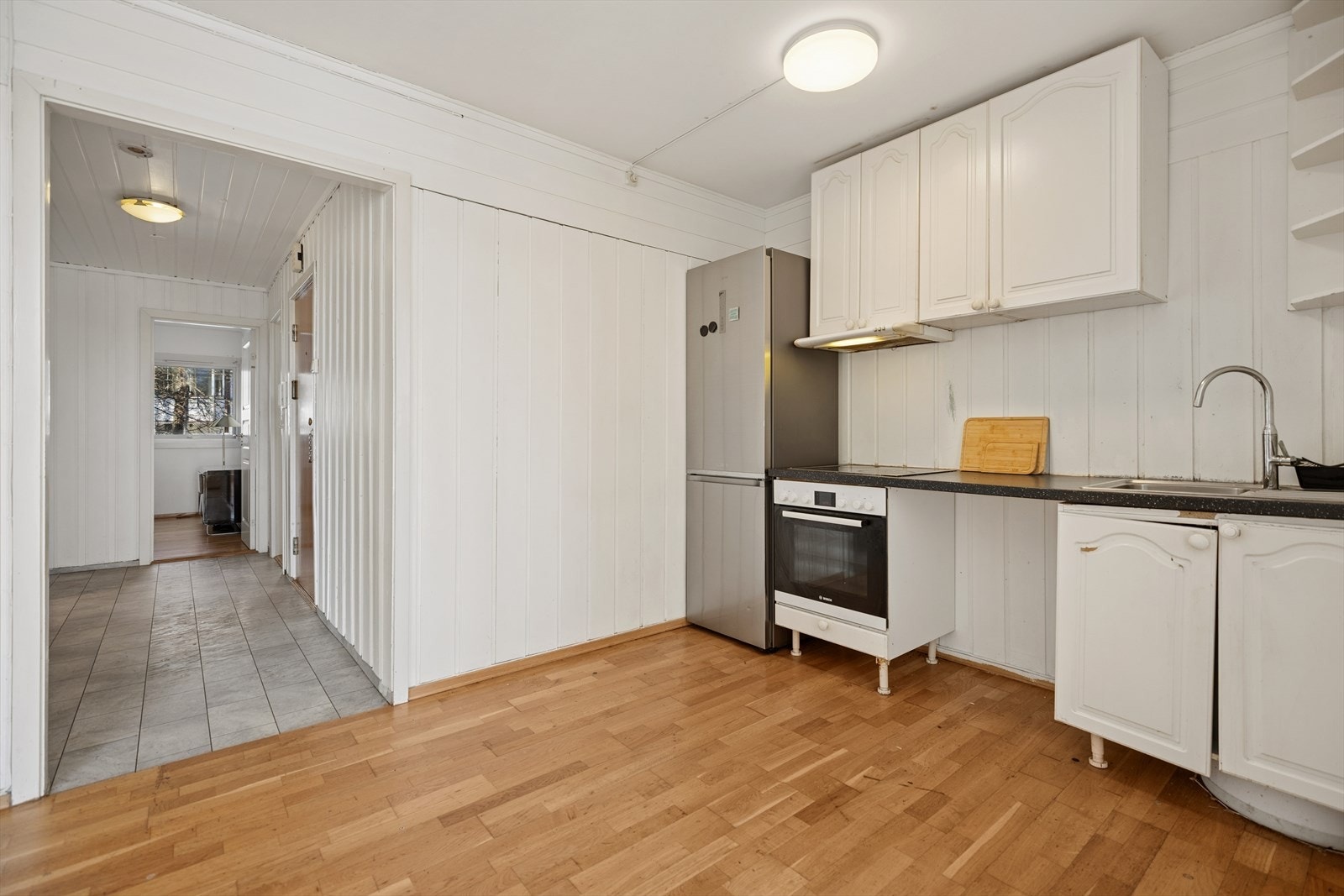 Videre inn i leiligheten kommer man til kjøkkenet. Kjøkkenet har en praktisk utforming med god arbeidsflyt Galleribilde