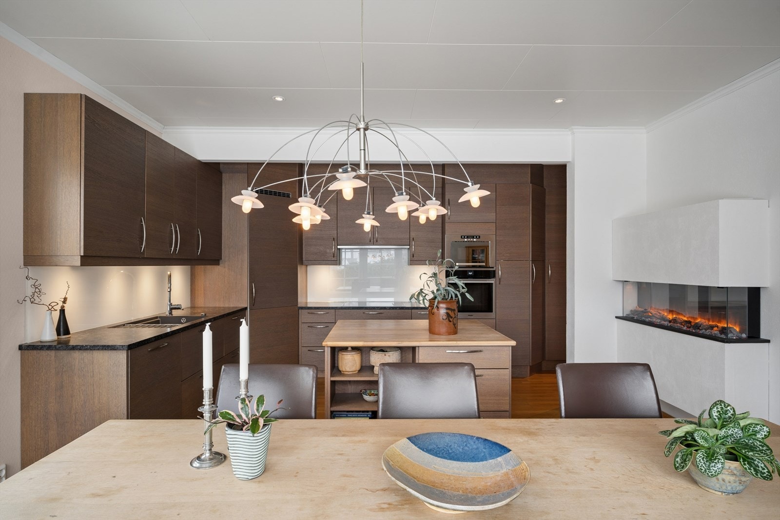 Kjøkkenet fra 2017 har moderne, glatte fronter og en benkeplate i granitt som gir rommet et elegant og tidløst preg. Fargekombinasjonen oppleves både behagelig og stilren. Galleribilde