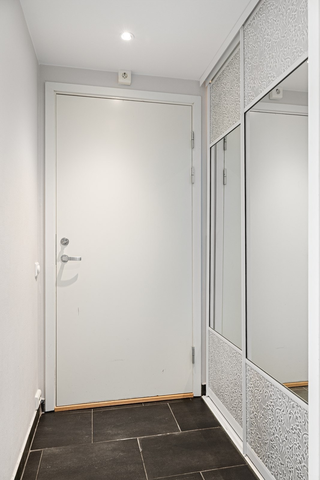 Entréen har fliser på gulv og romslig skyvedørsgarderobe med plass til oppheng av yttertøy. Galleribilde