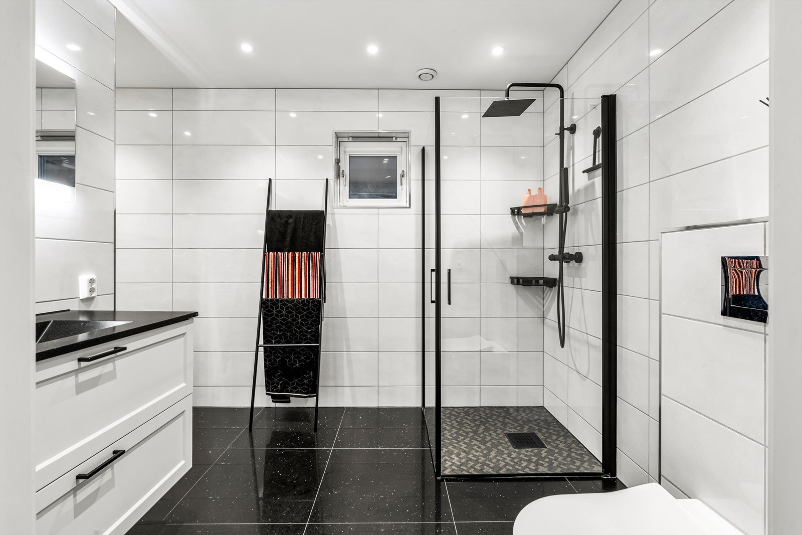 Lekkert bad/vaskerom som ble modernisert i 2019 av JF Bygg, Fixrør og Elfag. Det er fliser på vegg, fliser på gulv med termostatstyrte varmekabler og nedsenket himling med innfelte downlights. Galleribilde