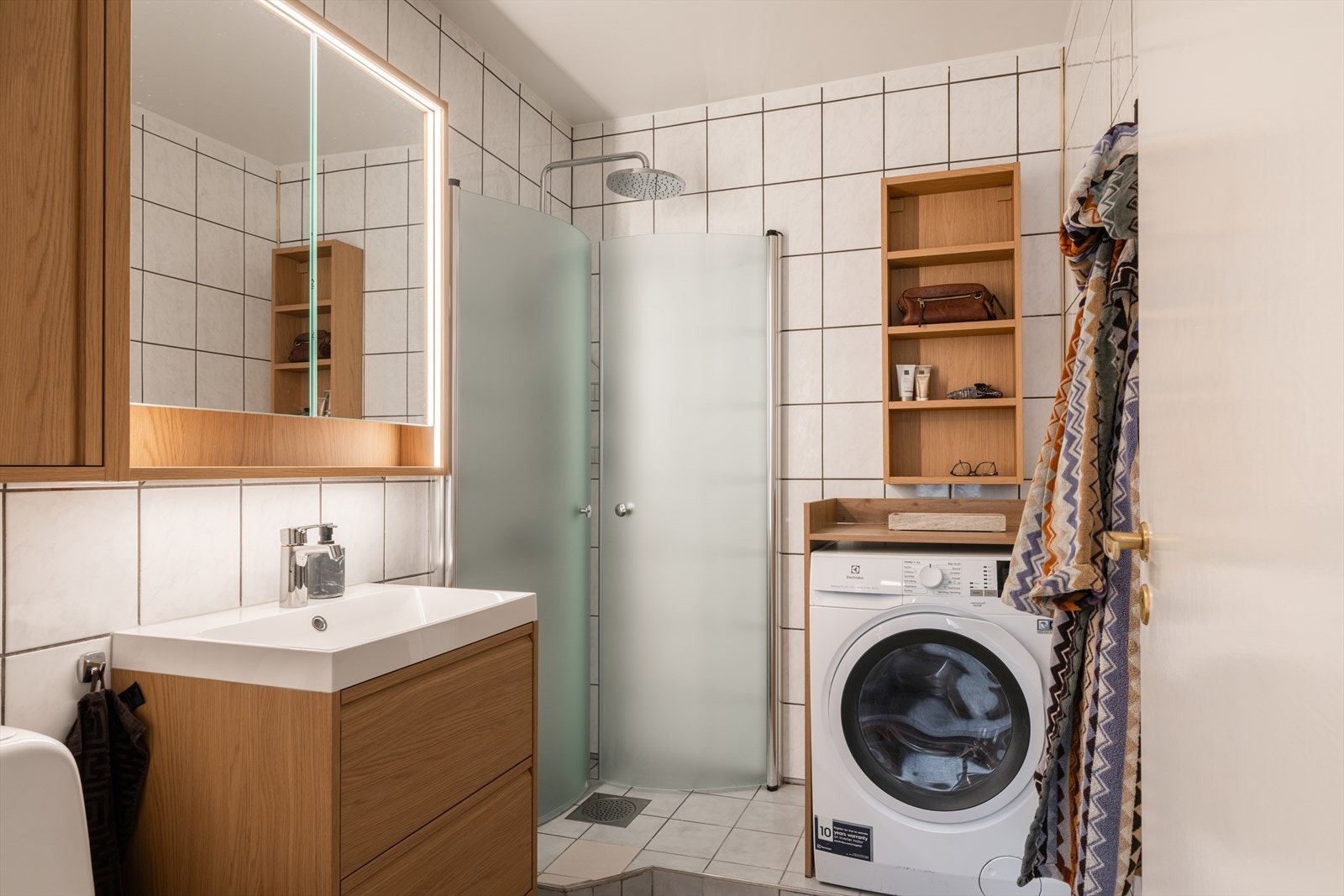 Flislagt bad med gulvvarme og opplegg til vaskemaskin. Galleribilde