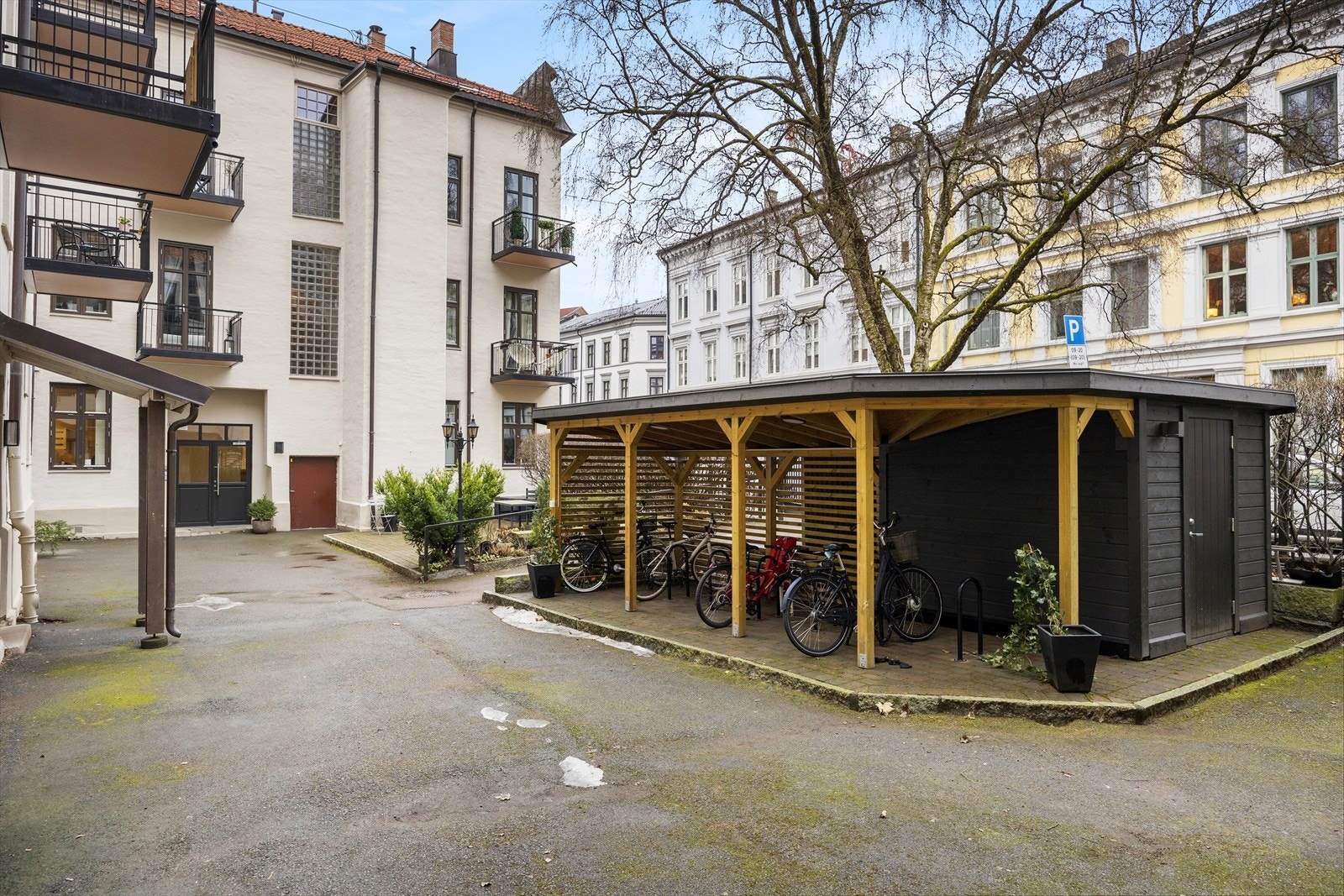 Hyggelig, inngjerdet gårdsrom med sykkelparkering Galleribilde