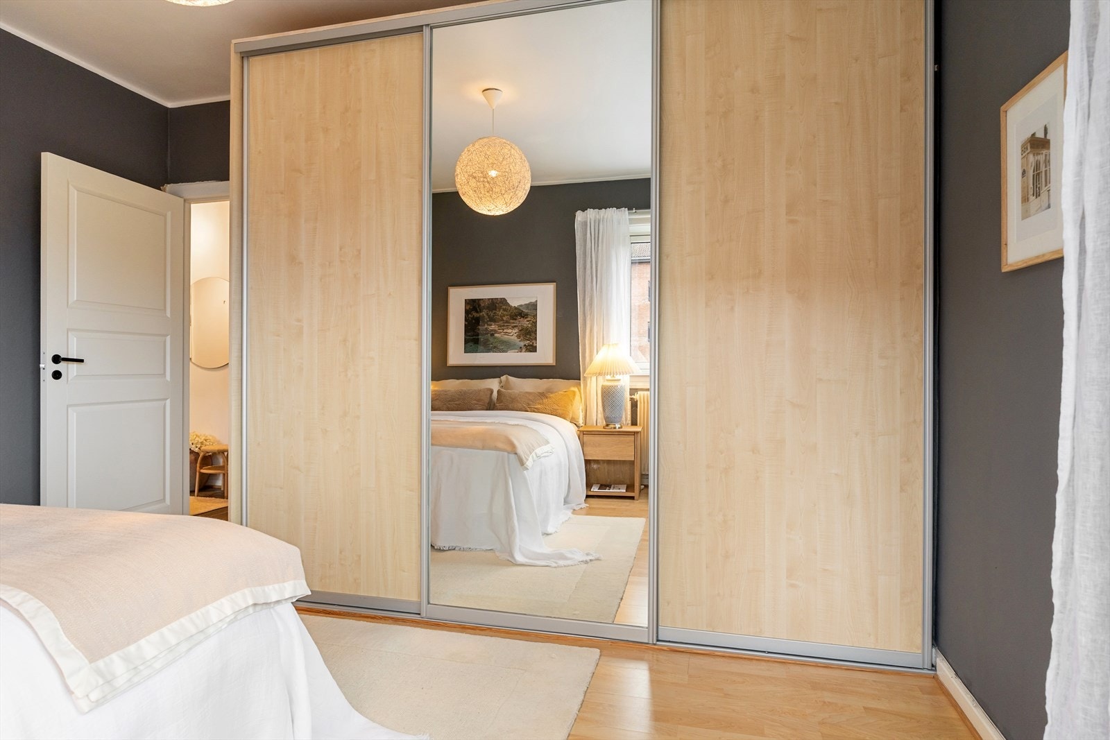 Det er god plass for oppbevaring i en stor skyvedørs garderobe på soverommet. Galleribilde