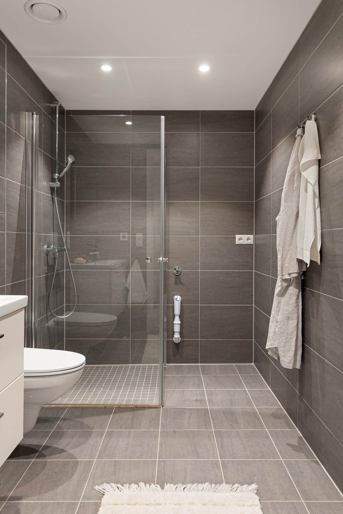 Innredningen består av dusjhjørne med svingbare glassdører som frigjør plass på gulvet. Galleribilde