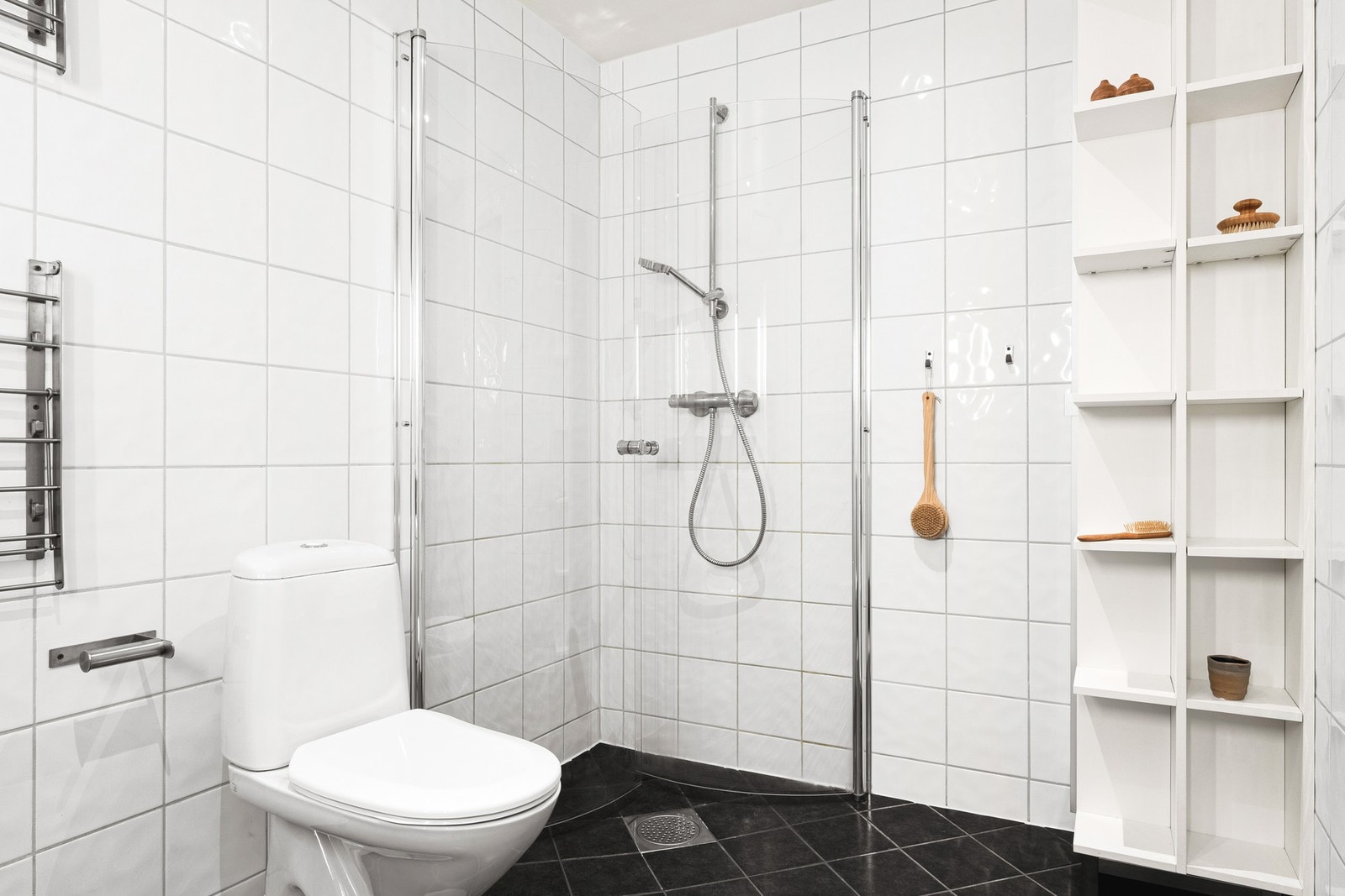 Badet er innredet med toalett, servant med innredning, dusjhjørne og opplegg for vaskemaskin. Galleribilde