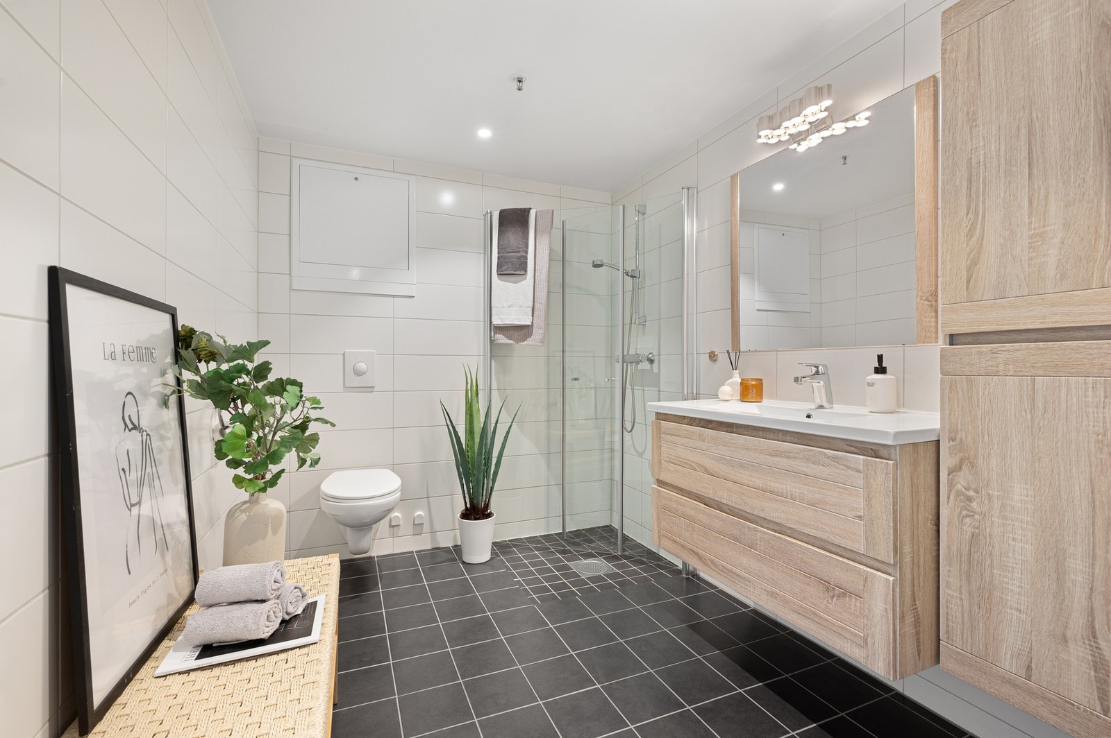 Romslig og helfliset bad på 5,5kvm. Det er varme i gulv og downlights i himling. Galleribilde