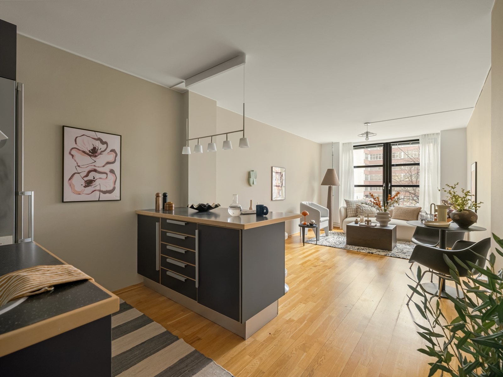 Forlenget benkeplate på kjøkkenøy gir mulighet for hyggelig frokostplass med to barstoler. Galleribilde