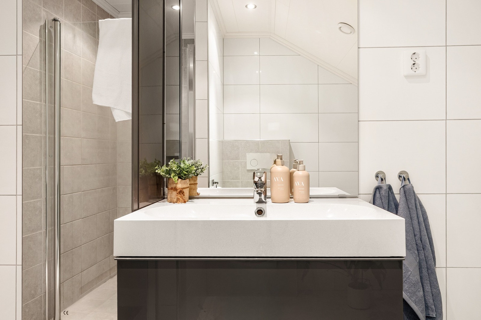 Det er innredet med vegghengt toalett, badekar, dusjnisje med garnityr og dør, samt baderomsmøblement med høyskap, speil og belysning. Galleribilde