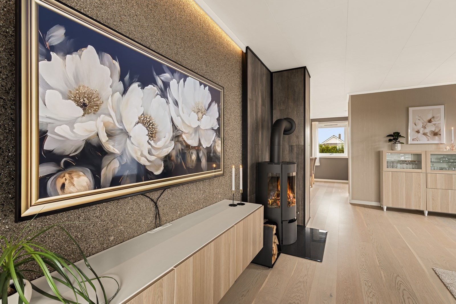 Midt i rommet finner man en flott Aduro peisovn installert i 2024, som skaper en lun og stemningsfull atmosfære på kjølige dager. Galleribilde