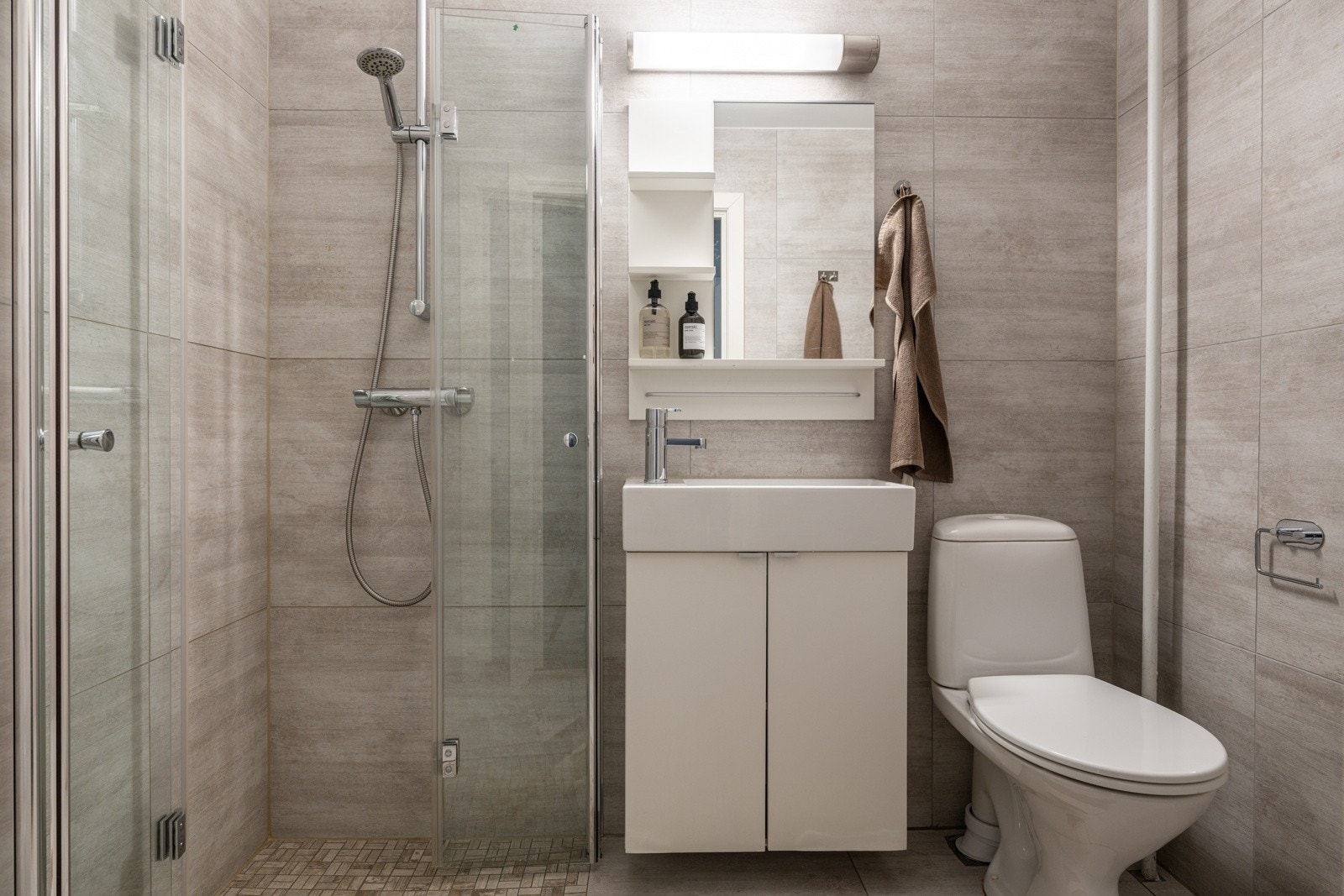 Leiligheten har et moderne baderom som ble oppgradert i 2016 med flis-på-flis og noe nytt interiør. Baderommet har fliser på gulv og vegger, elektriske varmekabler og mekanisk avtrekk. Galleribilde