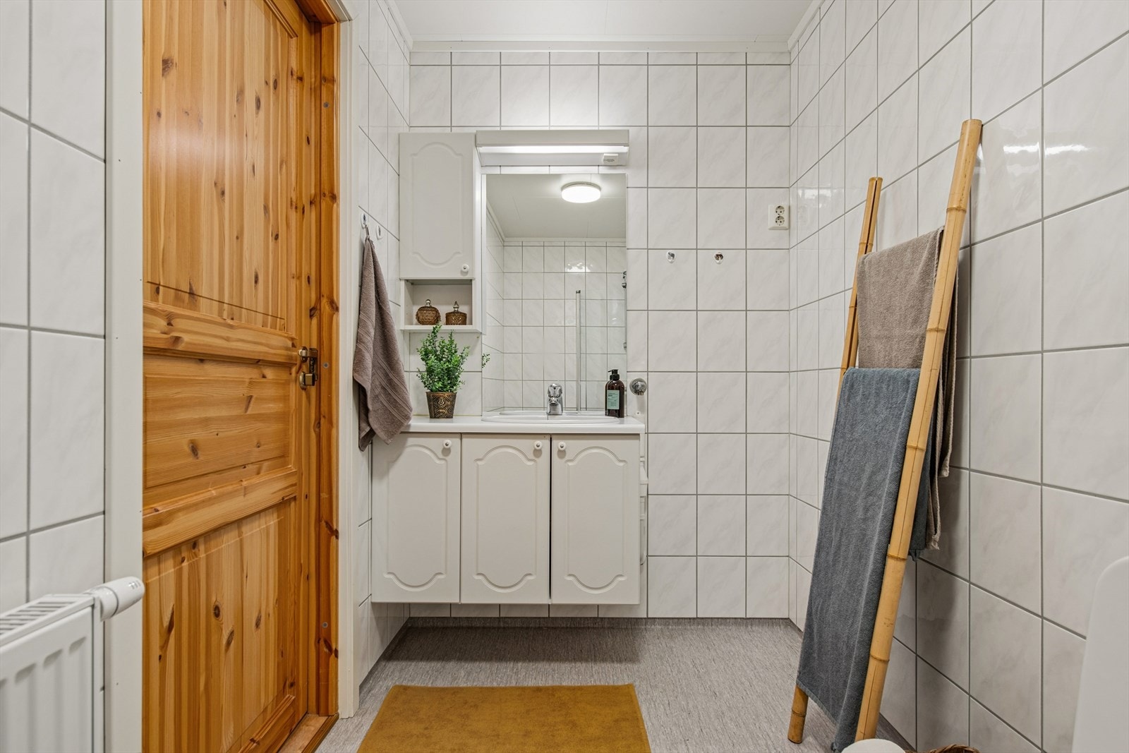 Badet har belegg på gulvet og flislagte vegger. Oppvarming skjer via veggmontert radiator med vannbåren varme. Galleribilde