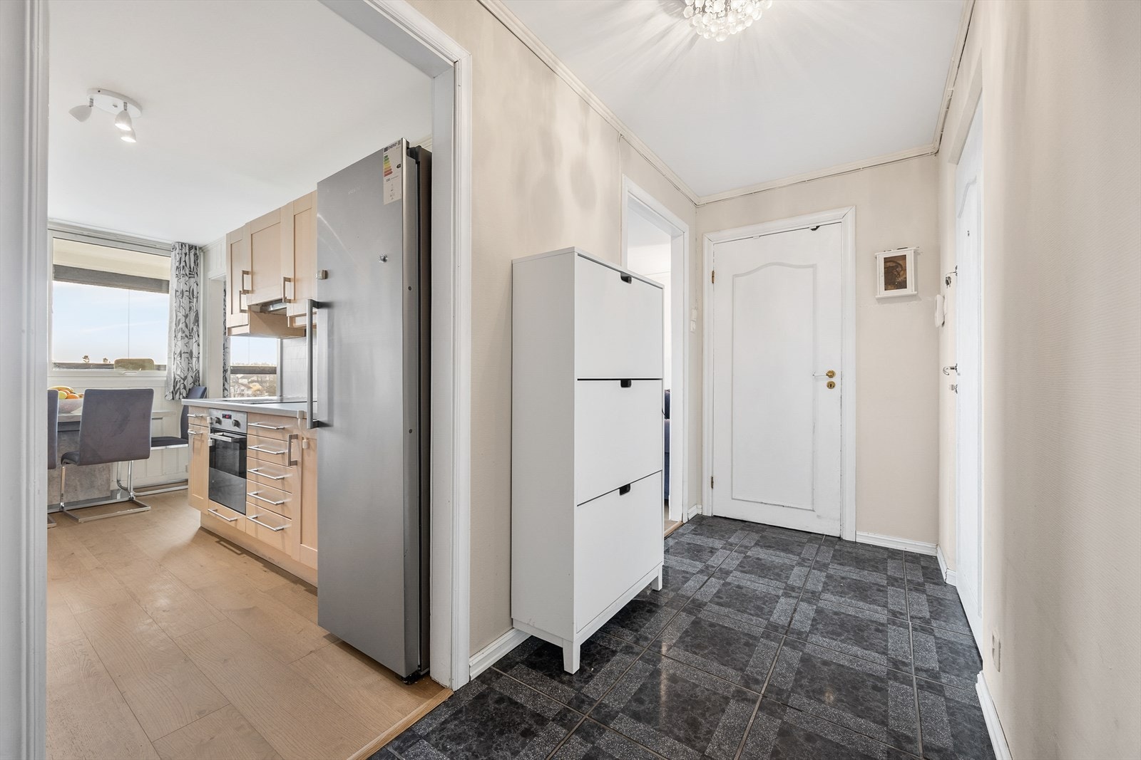 En åpen løsning fra gangen gir et glimt inn mot kjøkkenet og stuen. Galleribilde