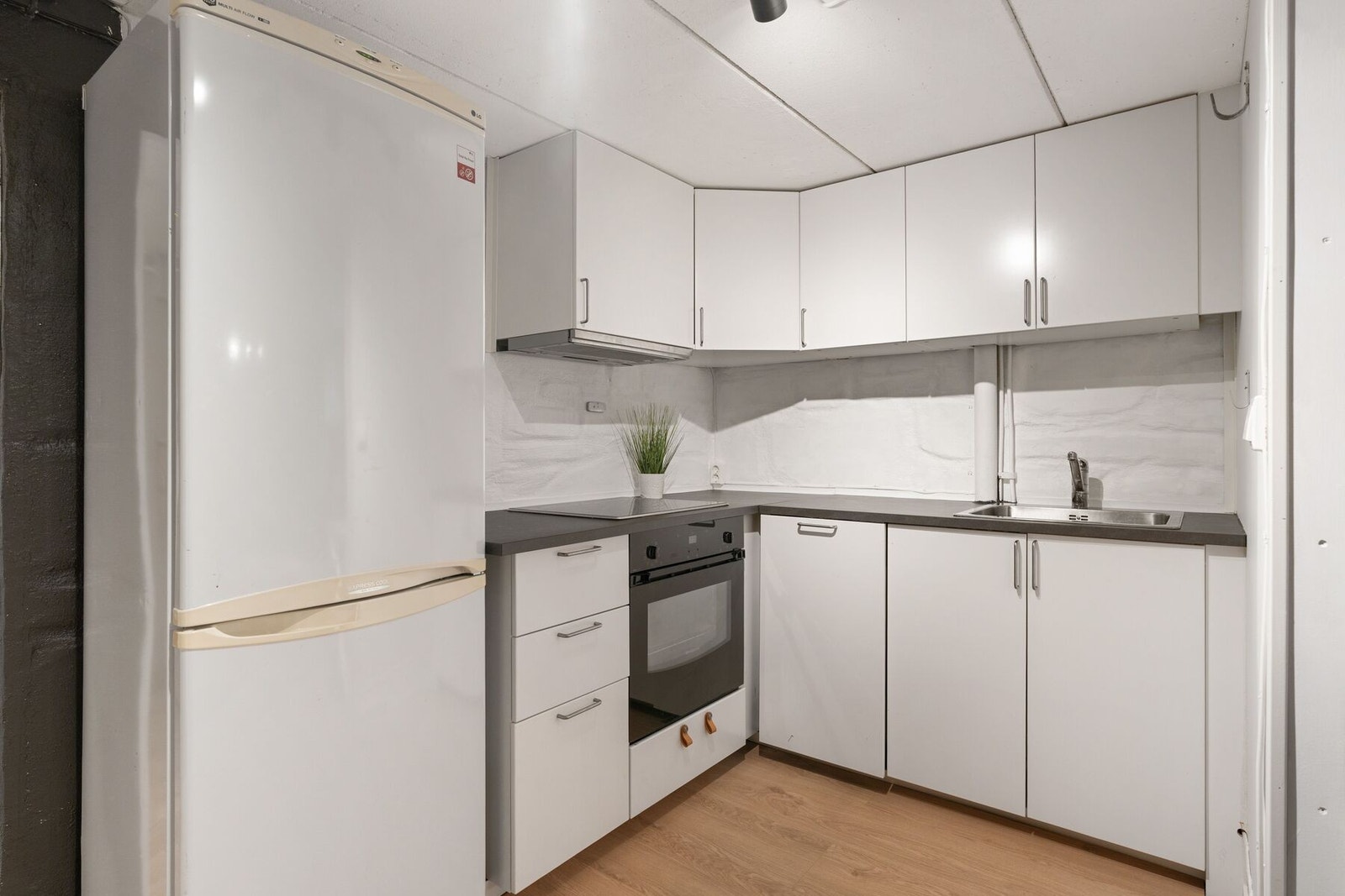 Stilren og nyere kjøkkeninnredning fra 2022 som byr på godt med benke- og skapplass. Galleribilde