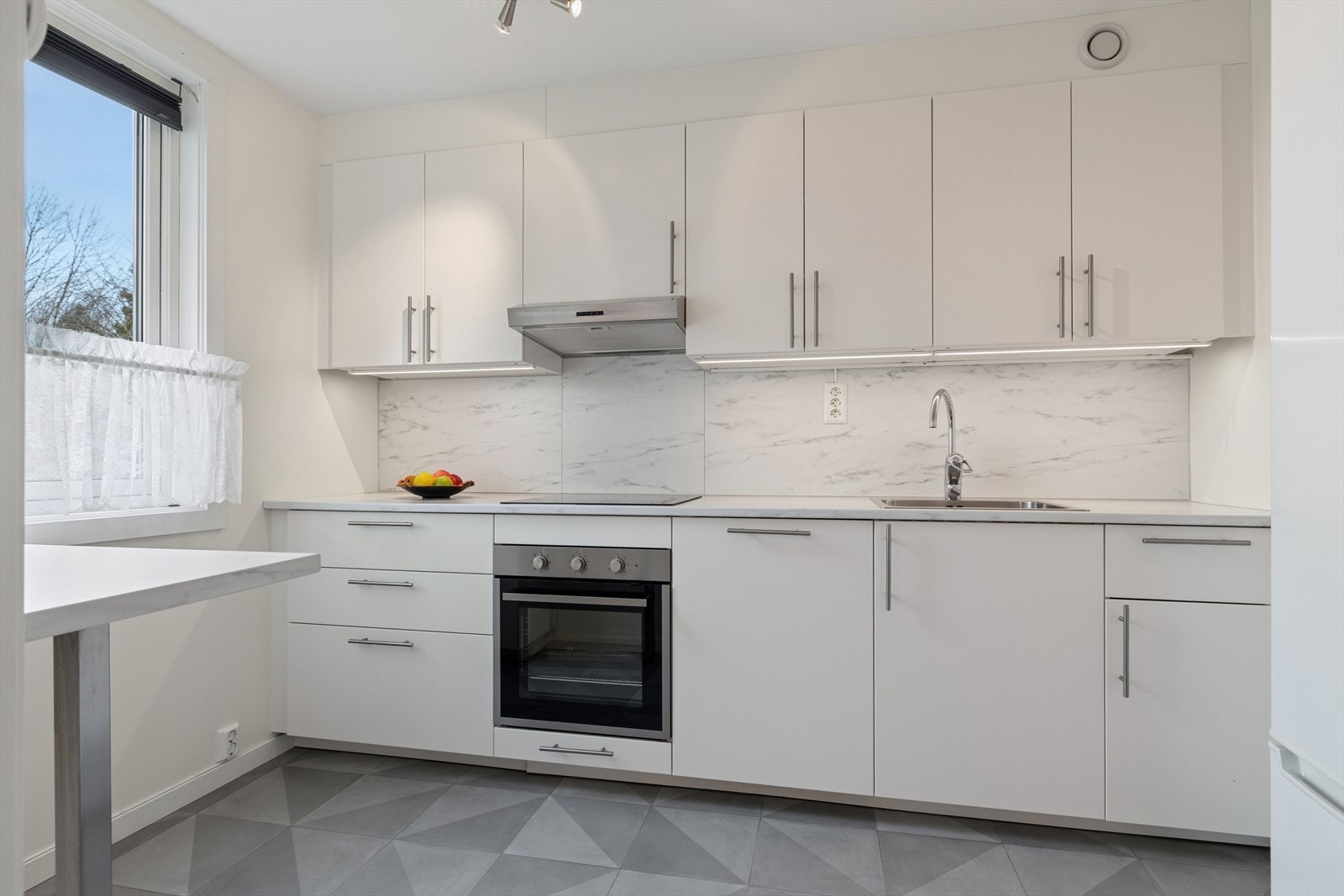 Kjøkkenet fra ca. 2019 har slette fronter og integrert komfyr, platetopp og oppvaskmaskin. Galleribilde