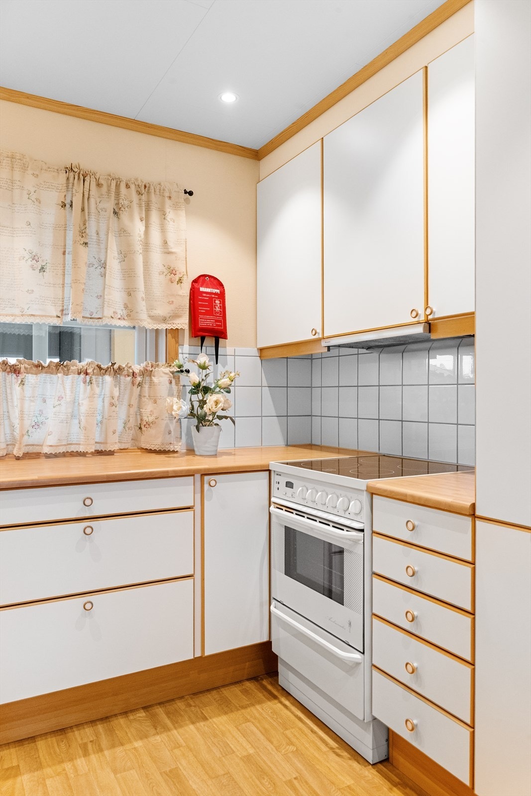 innredningen slette fronter og laminert benkeplate med nedfelt dobbelt oppvaskkum. Det er avsatt plass til frittstående hvitevarer som kjøleskap, komfyr og oppvaskmaskin i innredningen. Galleribilde