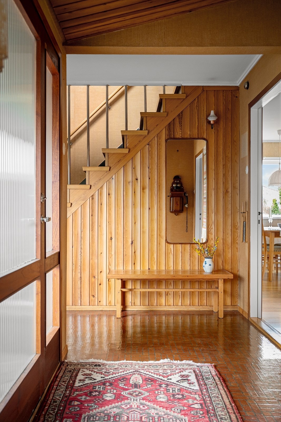 Hovedentre og gang med stilfulle arkitektoniske detaljer som dører med glass, bruken av tre og trapp med stålspiler. Rom for sittebenk, kommoder og mer. Galleribilde