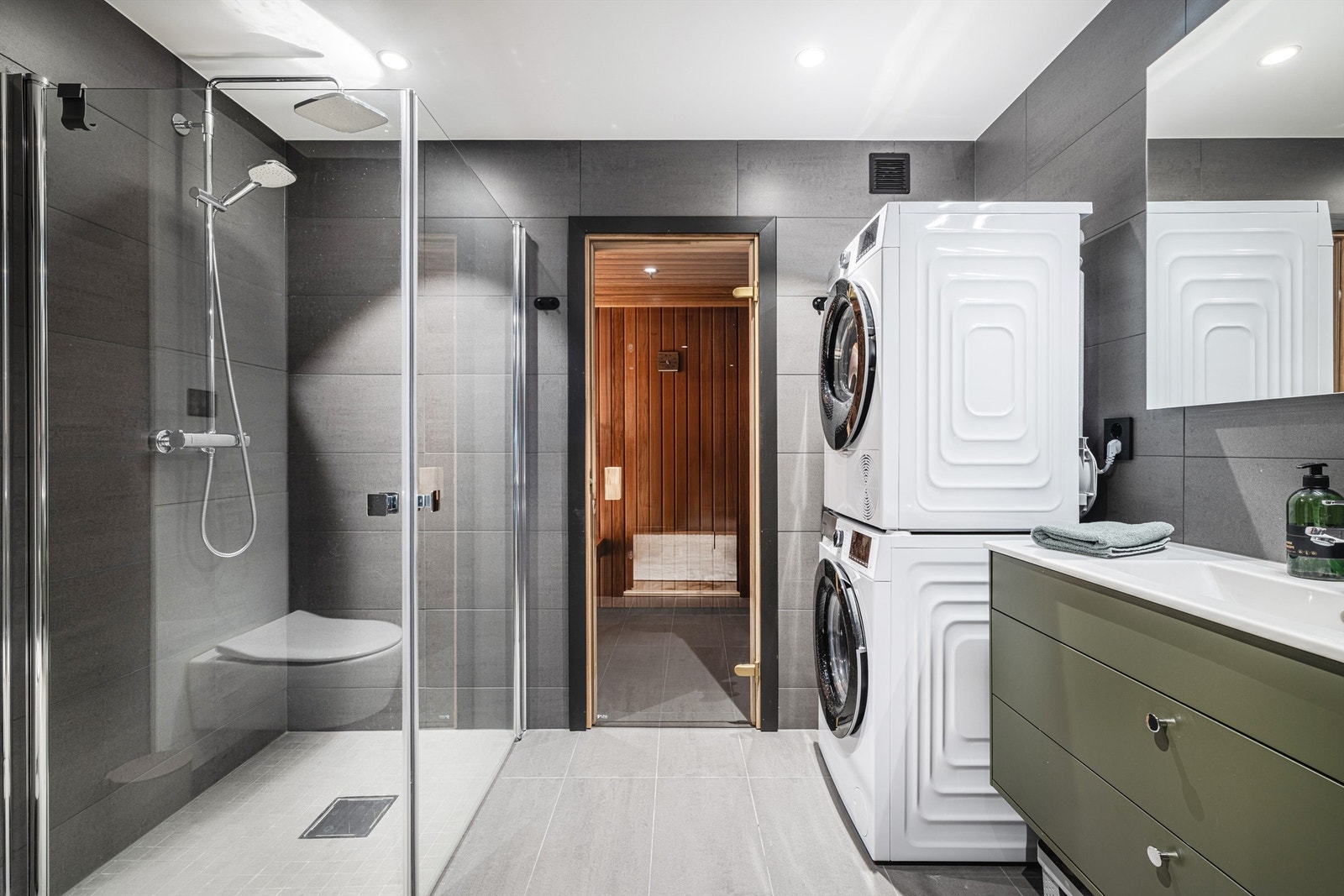 Leiligheten har to delikate bad. Dette badet har flislagte flater, innredning fra Sigdal og inngang til egen badstue. Galleribilde