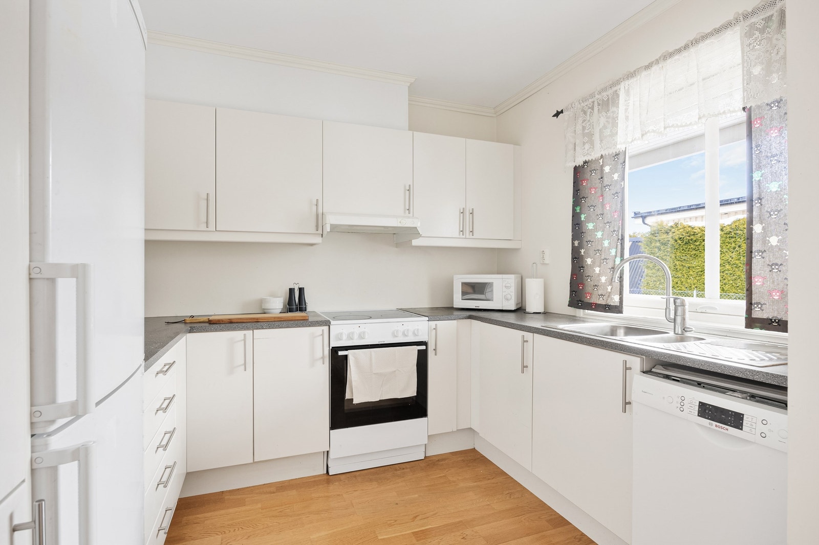 Kjøkkenet er utstyrt med frittstående hvitevarer og ventilator i overskap. Galleribilde