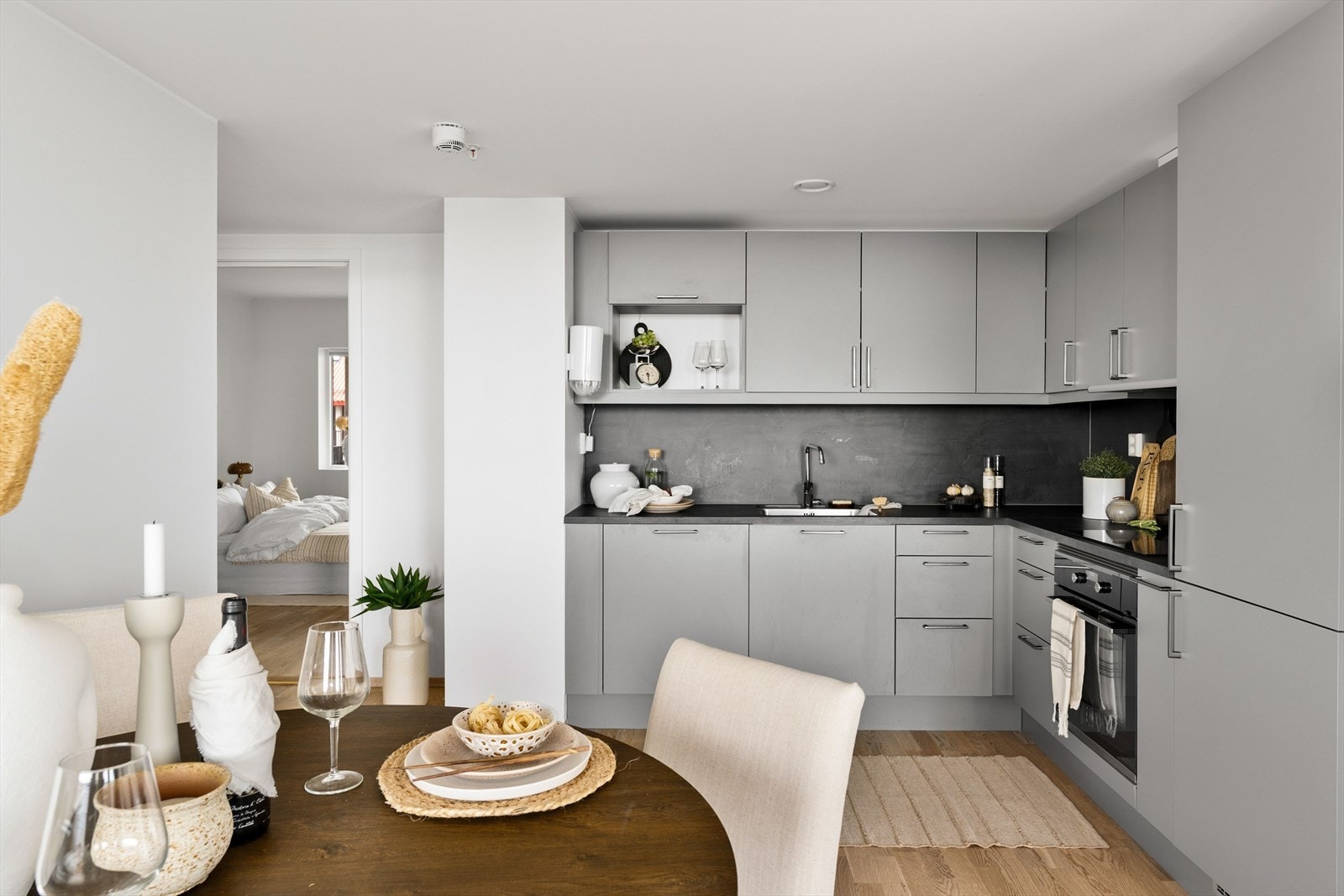 Kjøkkenet fremstår stilrent med grå overflater og sort benkeplate. Galleribilde