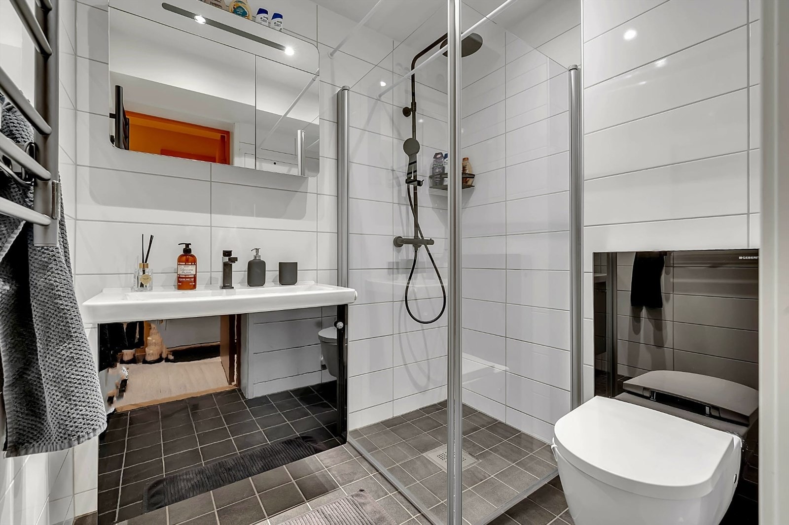 Moderne og praktiske innredninger, med oppbevaring i innredning, dusjvegger av glass og vegghengt toalett. Galleribilde