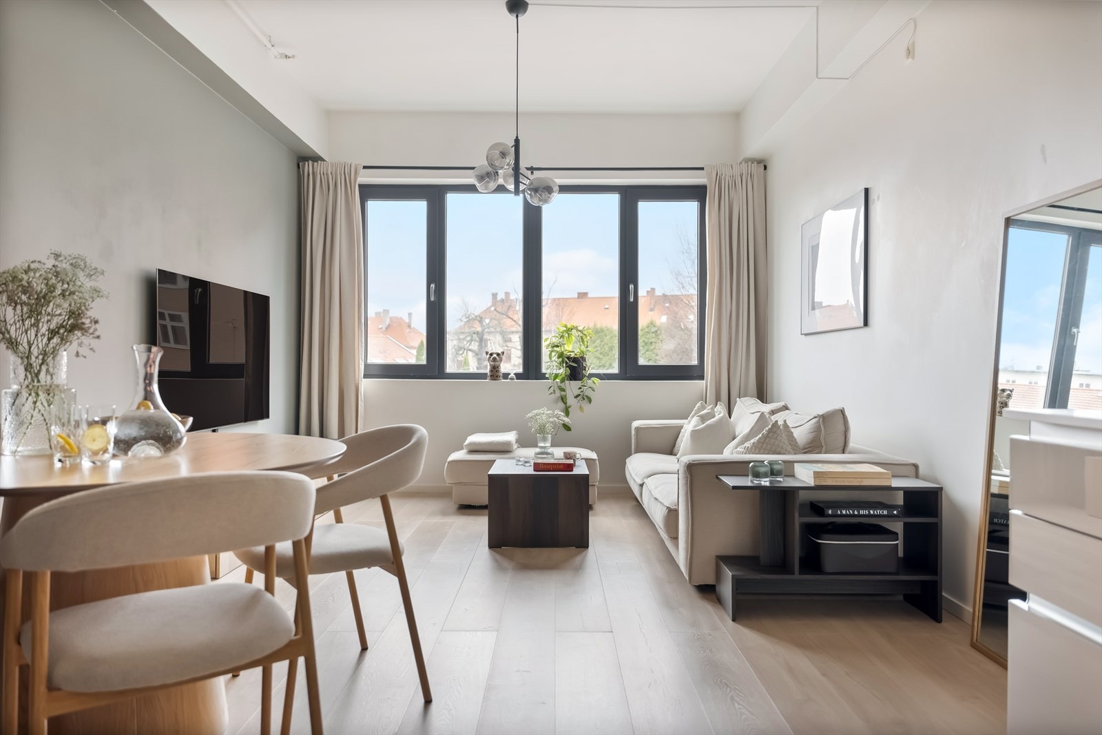 Lys og fin stue med pen laminat på gulv og lysmalte vegger. Galleribilde