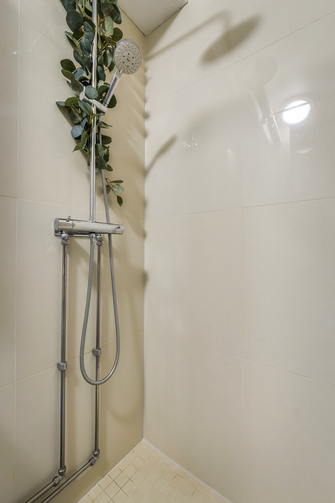 Badet har flis på gulv og vegger, og taket er av pusset mur. Det er naturlig avtrekk og tilluft under dør. Galleribilde