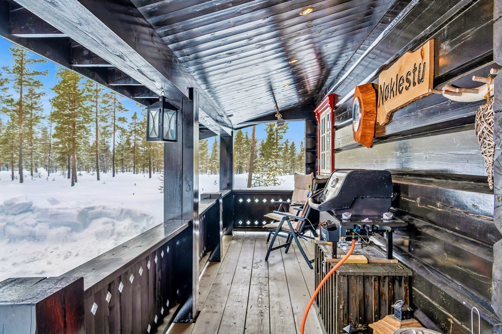 Verandaen er oppført i impregnert trevirke og har et rekkverk i malt tre. Galleribilde