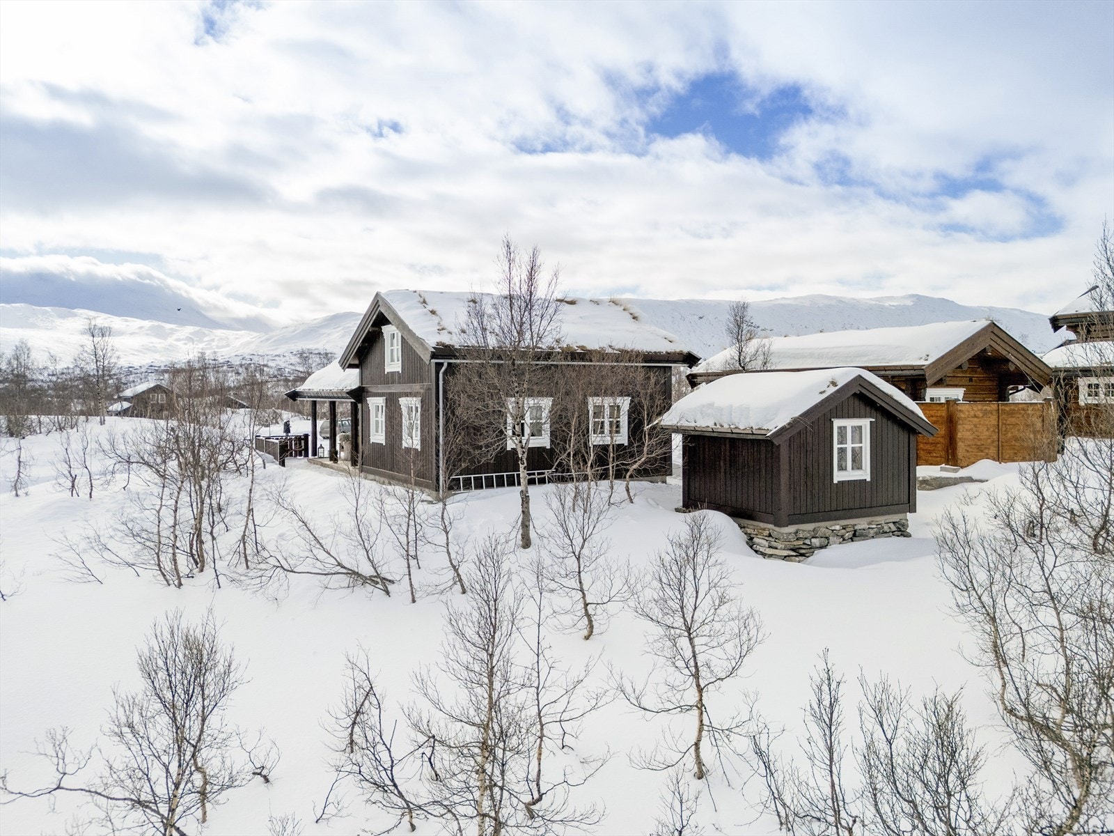 Eiendommen består av en innholdsrik hytte, en frittstående utebod og et leskjul i samme stil. Galleribilde