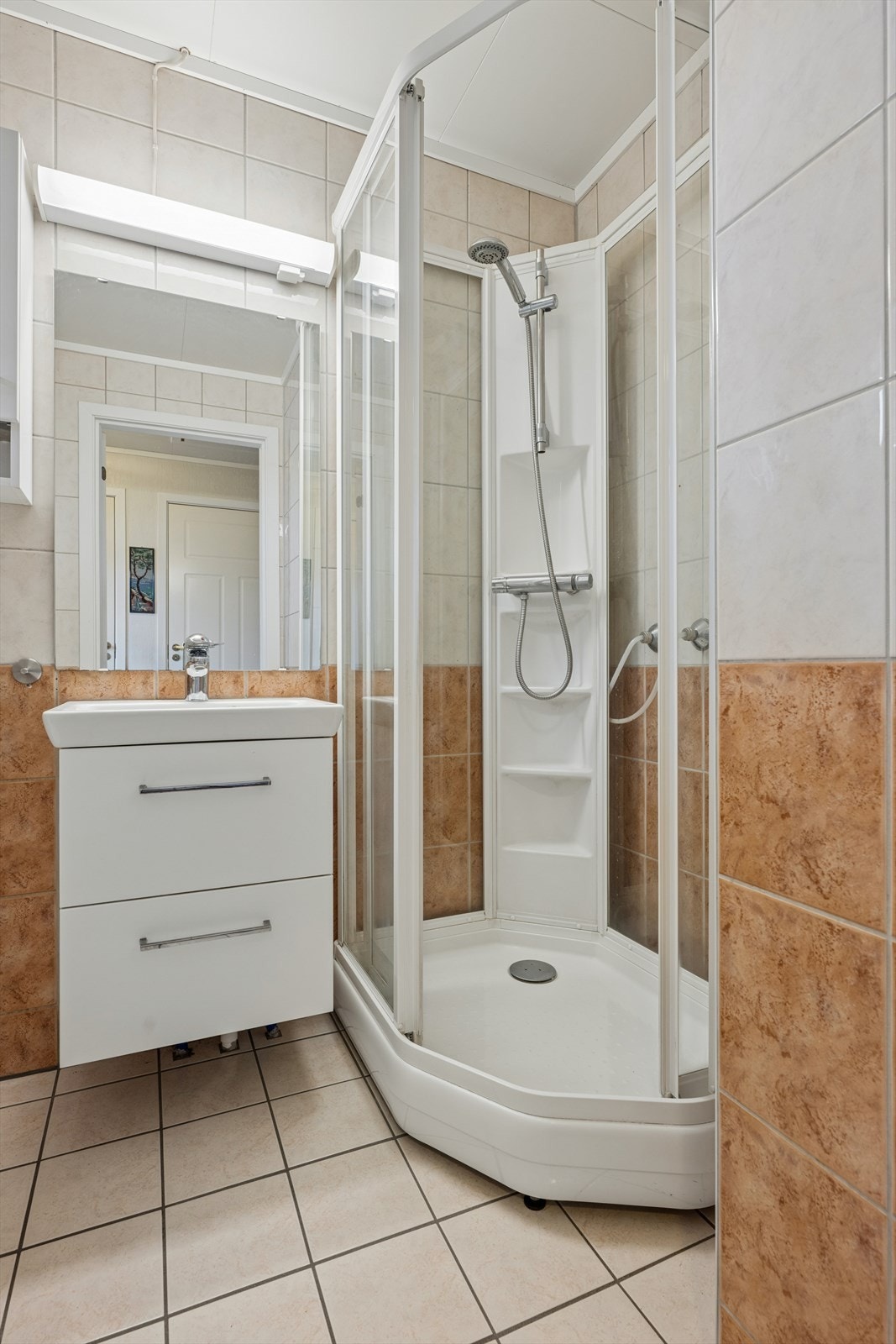 Badet i første etasje har flislagt gulv med gulvvarme og fliser på veggene. Galleribilde