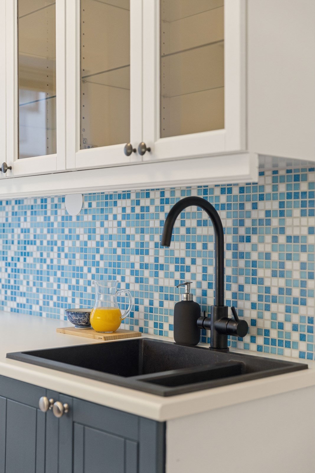 Detaljer som den sorte vasken og armaturet gir kjøkkenet et moderne preg. Galleribilde