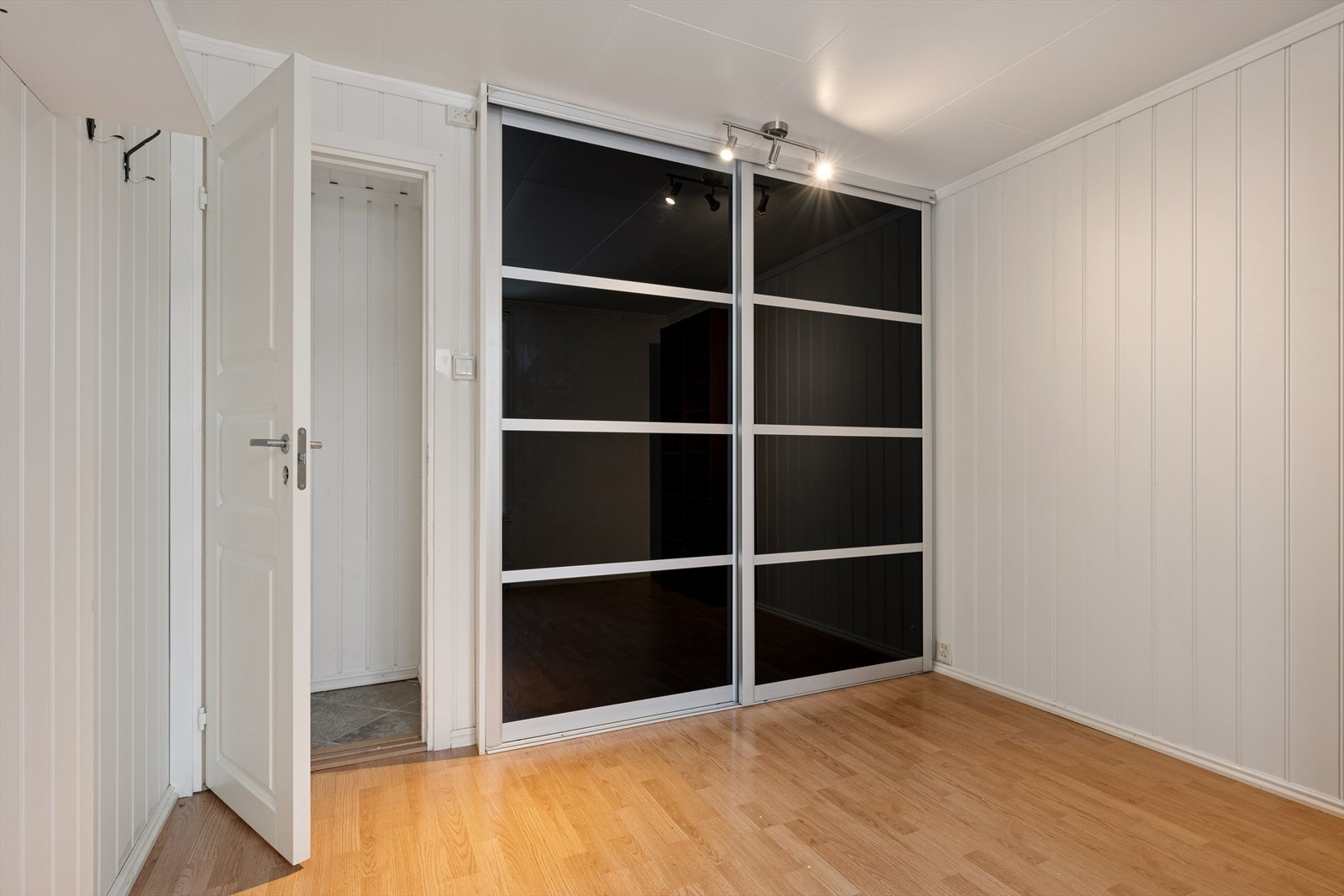 Det er montert en stor skyvedørsgarderobe med praktisk plassert lys. Galleribilde