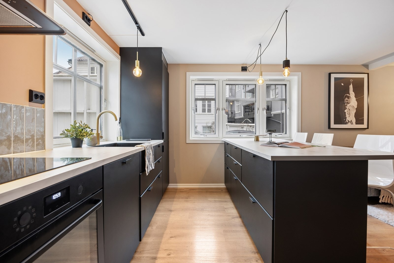 Stilrent kjøkken (2021/22) med glatte fronter og laminat benkeplate. Mekanisk avtrekk. Galleribilde