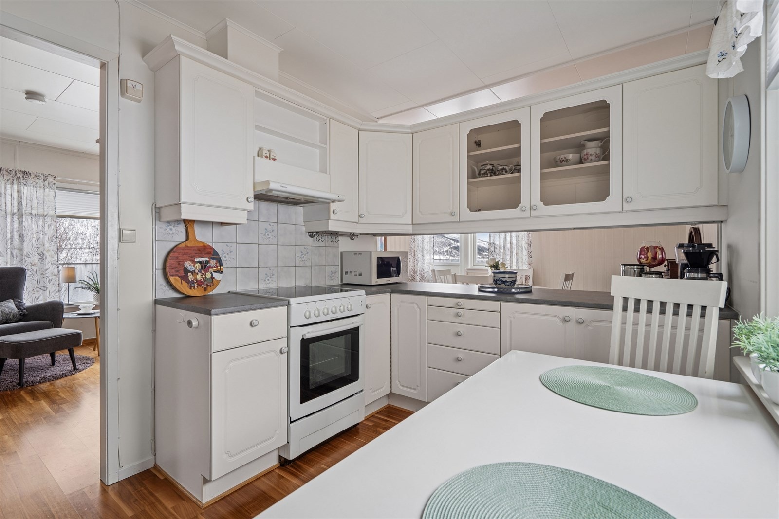 Kjøkkenet er innredet med hvite, profilerte fronter og grå benkeplate i laminat. Et romslig kjøkken som gir godt med skap- og skuffeplass, samt gode arbeidsflater på benk. Galleribilde