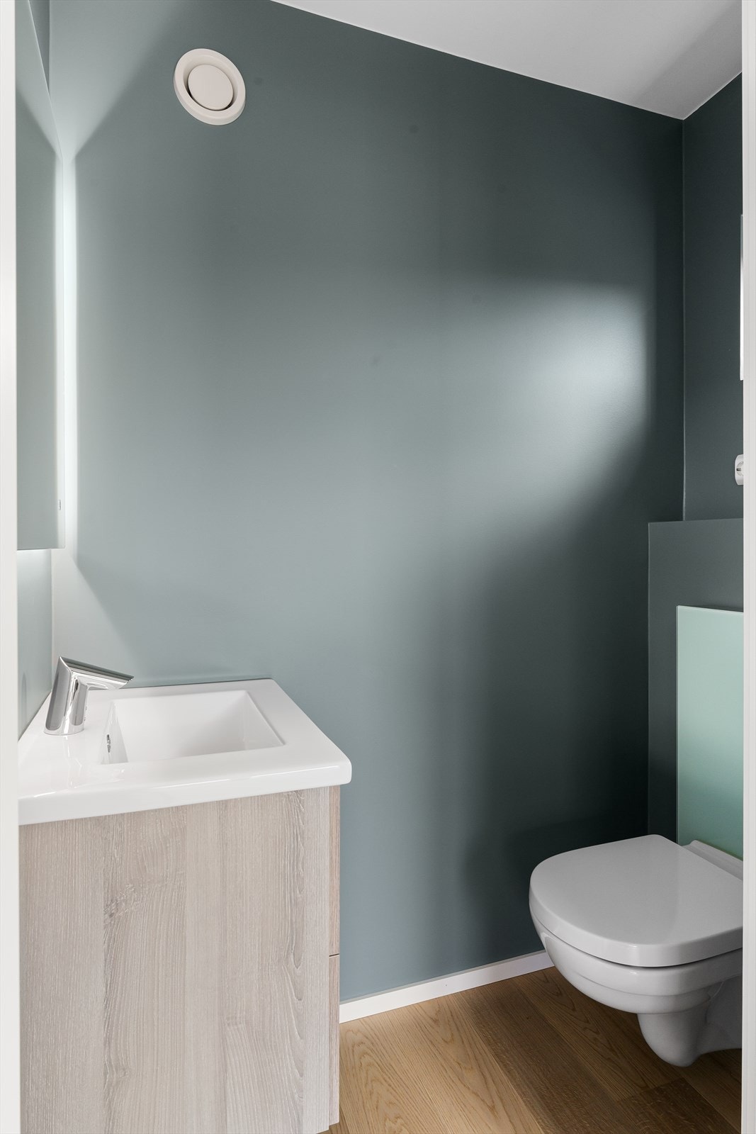 Toalettrom innredet med vask og vegghengt toalett. Galleribilde