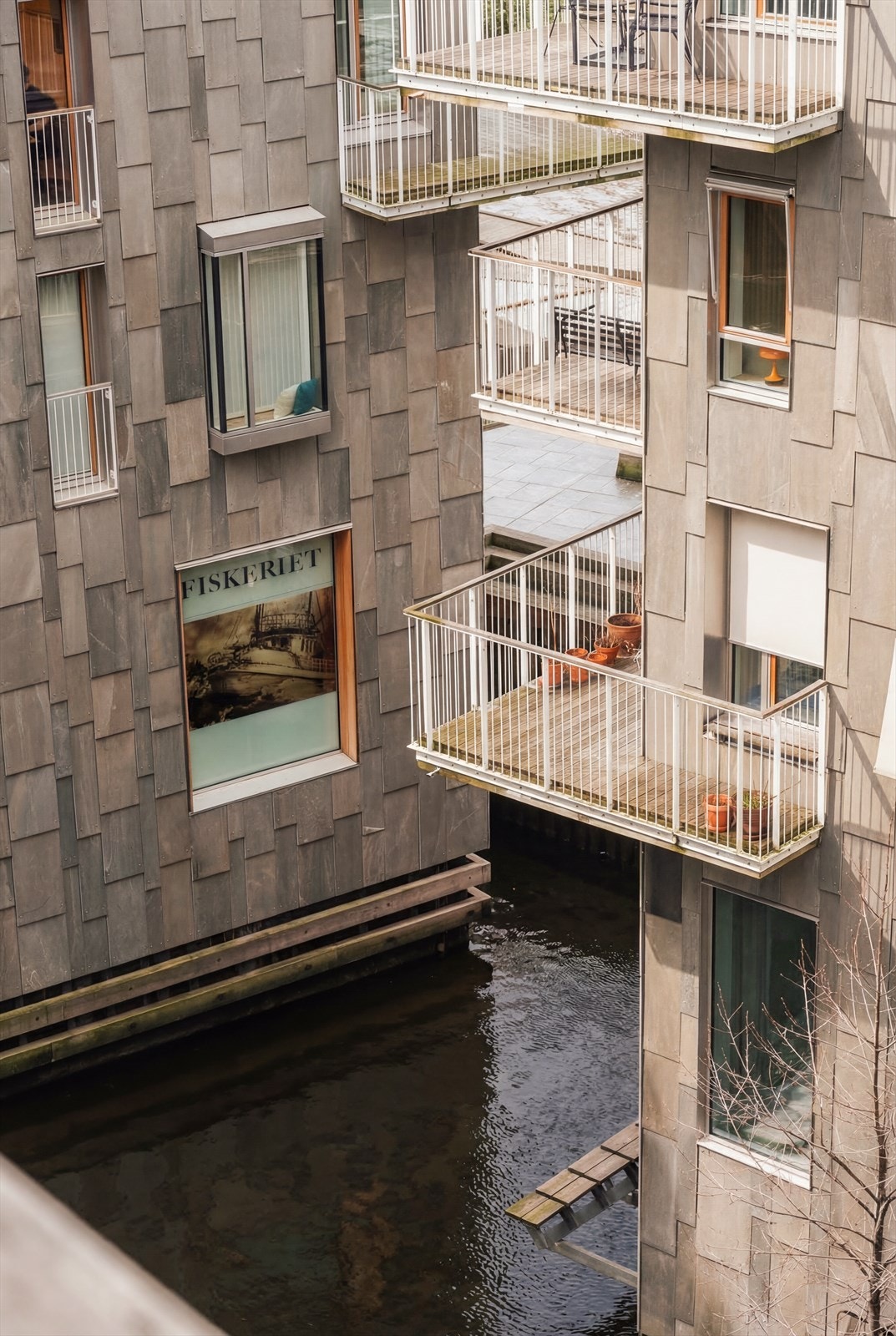 Her bor dere i et nabolag med særpreget arkitektur, oppført i sjøen med kanaler og vannspeil mellom byggene. Galleribilde