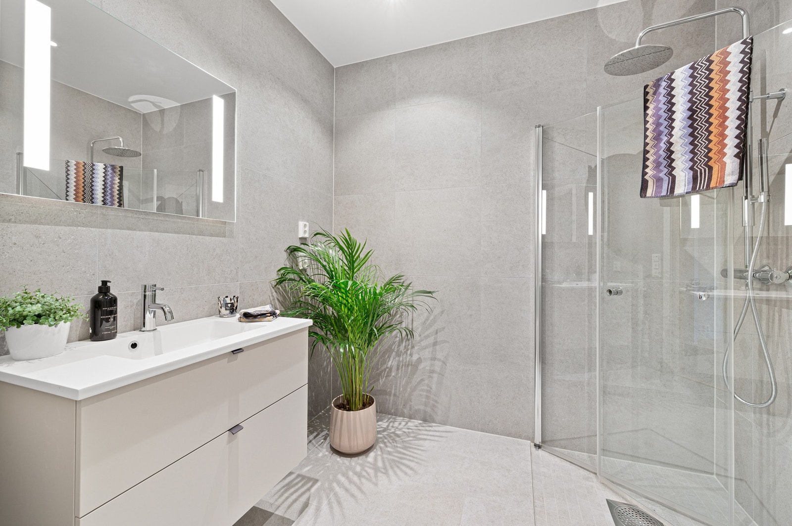 Av inventar finner dusjnisje med regndusj, vegghengt skuffeseksjon, vegghengt toalett og speil. Galleribilde