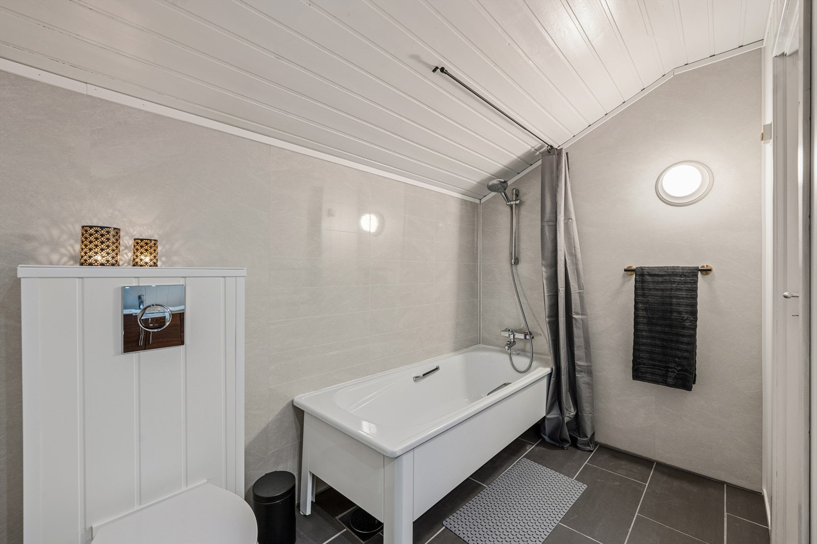 Baderom i loftsetasjen er innredet med badekar, nedfelt servant og veggmontert toalett. Galleribilde