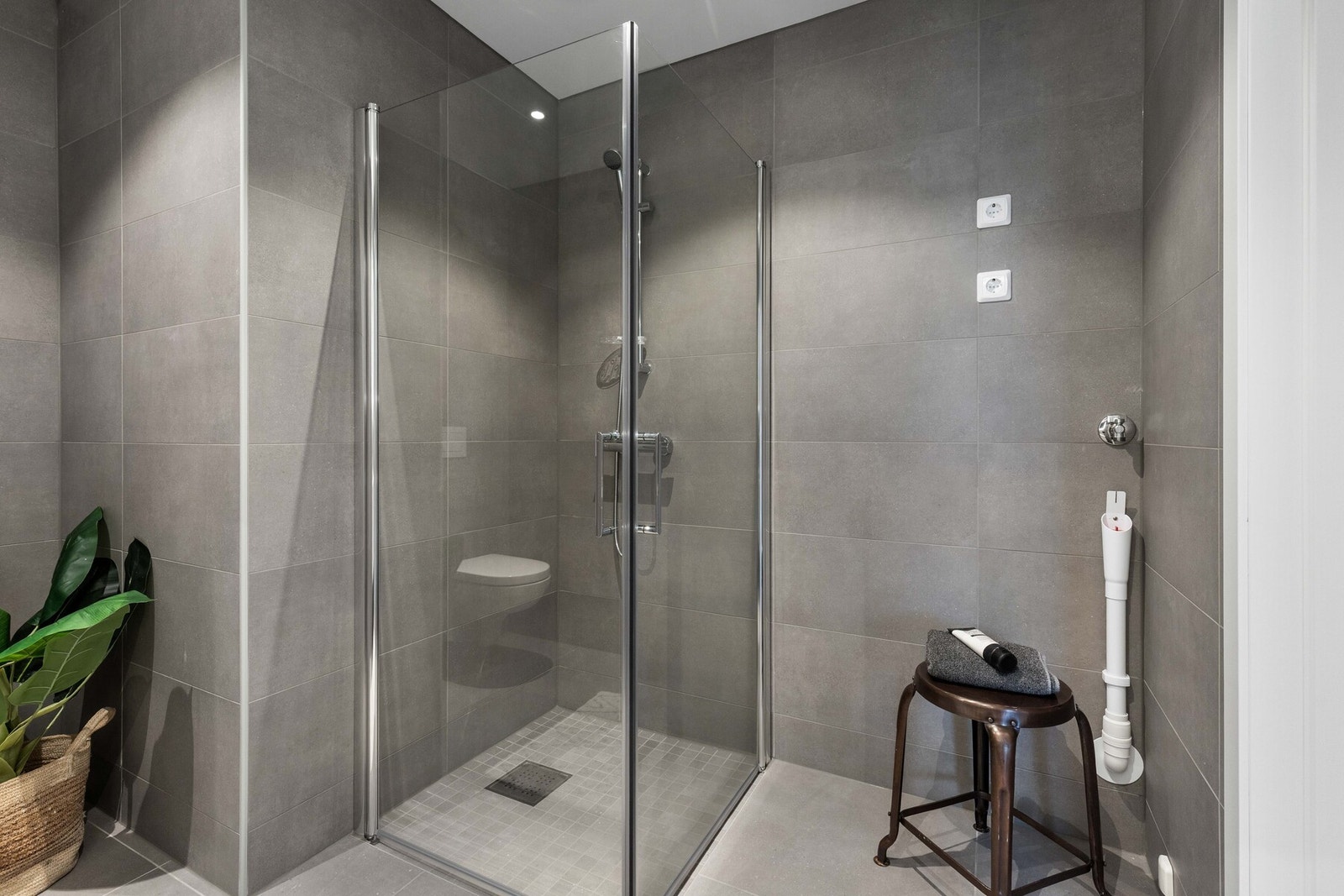 Baderomsinnredning med god oppbevaring og dusjnisje med glassvegger Galleribilde