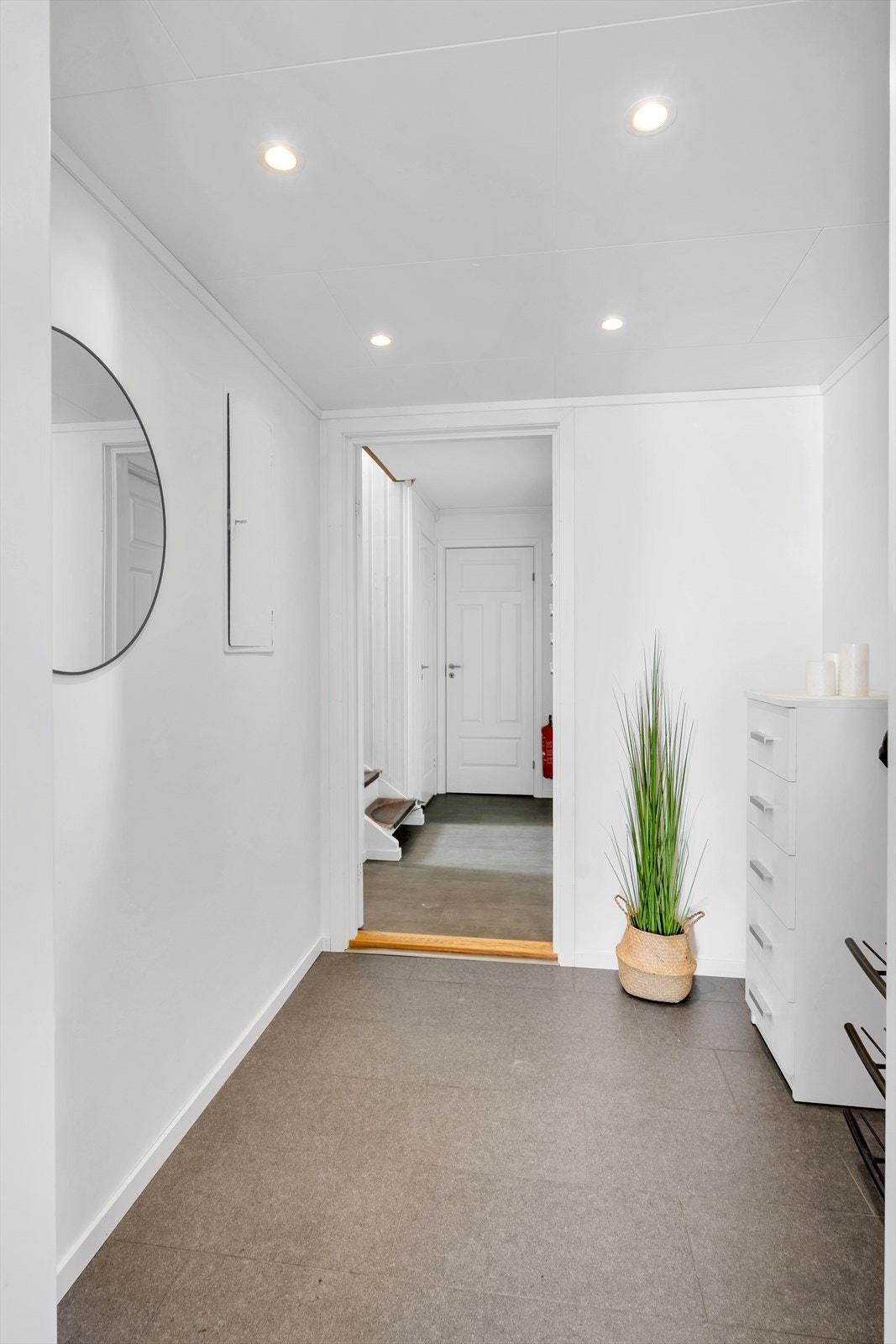 Stor og flott flislagt entre med varme i gulv samt downlights i himling Galleribilde