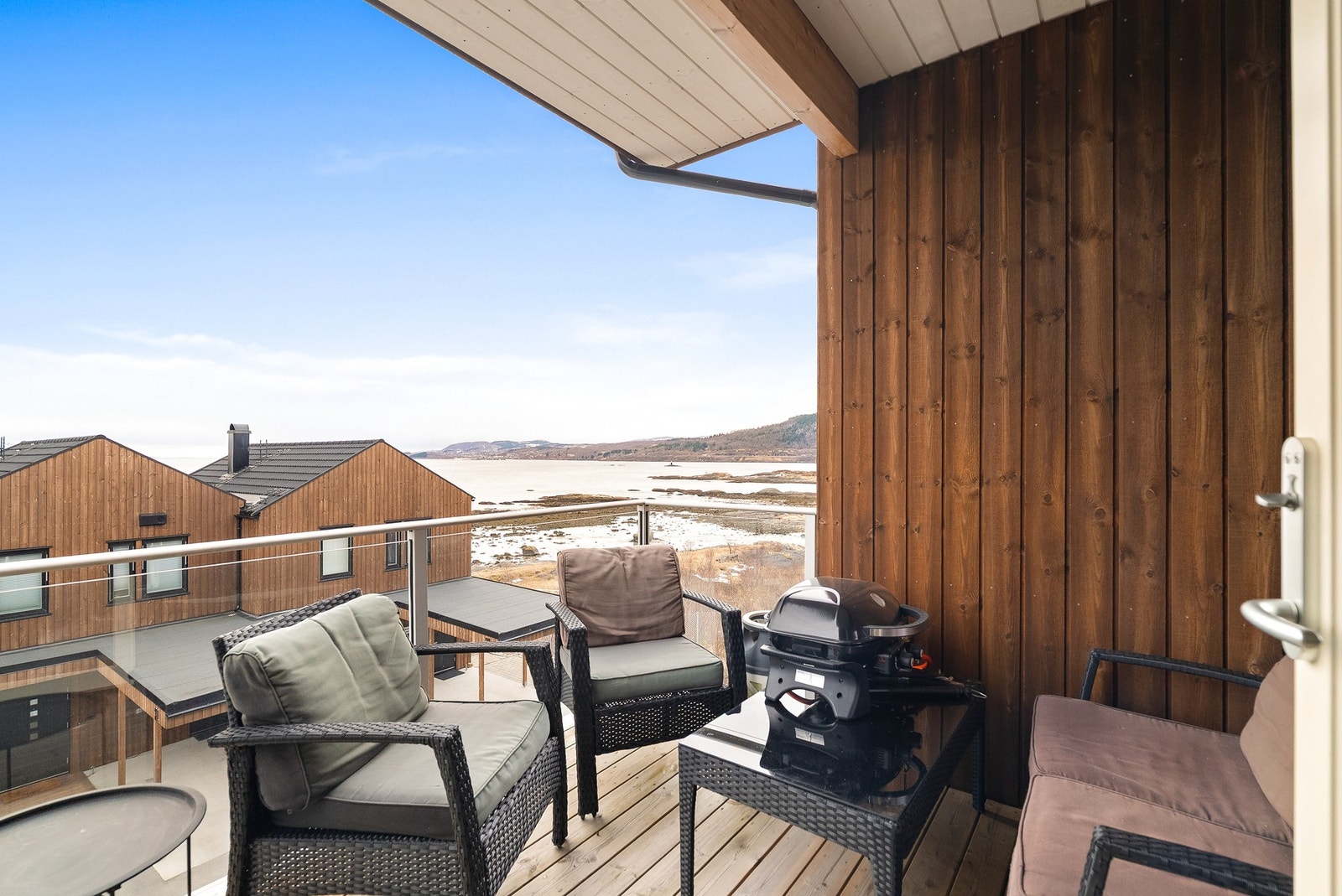 Utgang fra stua til en overbygd balkong med gode sol- og utsiktsforhold. Galleribilde