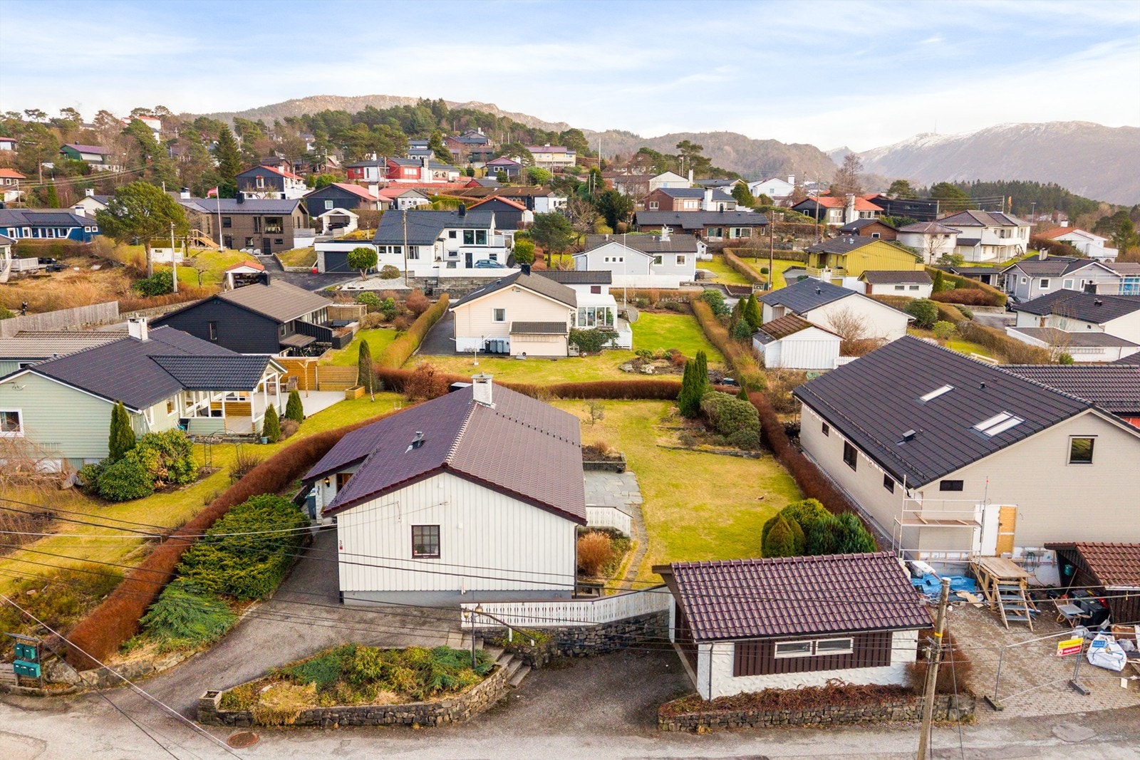 Asfaltert innkjørsel med biloppstillingsplass og garasje. Galleribilde