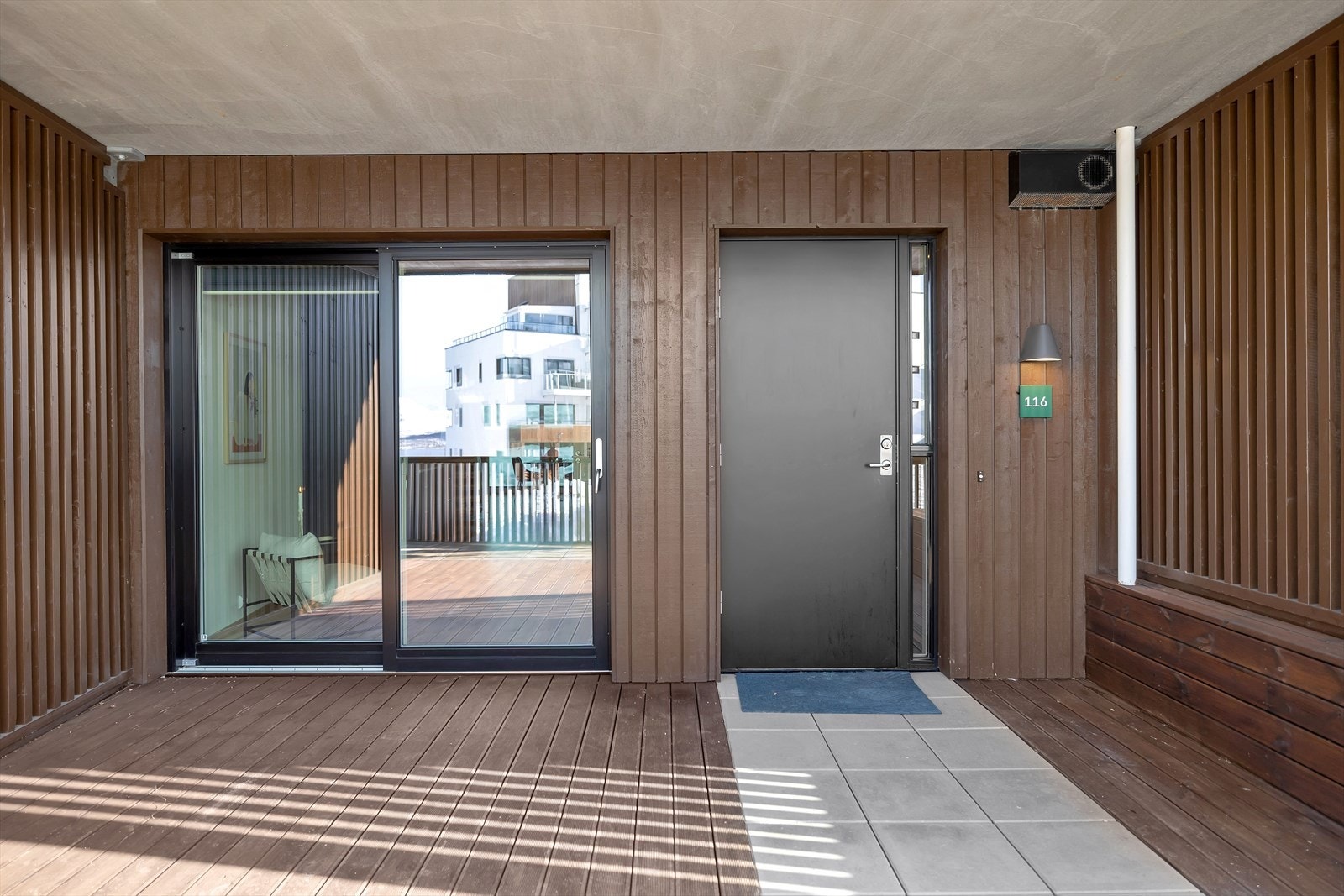 Eget inngangsparti som kan benyttes til å lagre sykler og andre praktiske hverdags remedier samt. Det er også plass til et hagebord og stoler her. Galleribilde