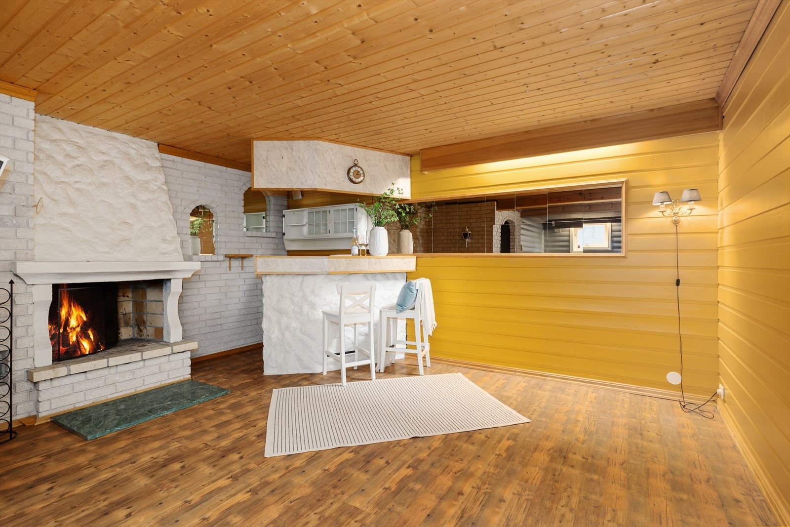 I stuen er det en koselig, åpen peis som gir en lun atmosfære i rommet. Galleribilde