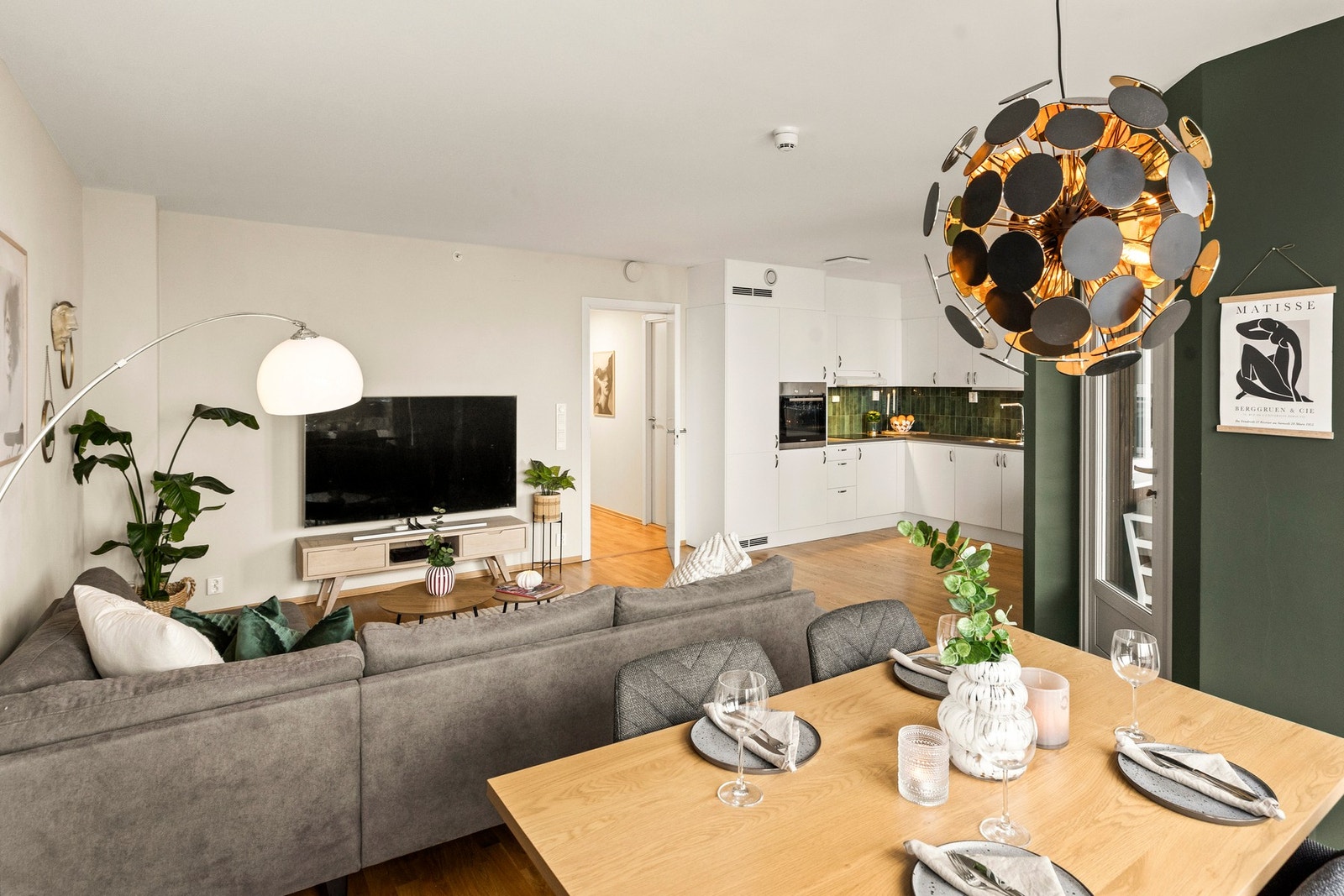 Den åpne løsningen mot kjøkkenet gjør stuen til et naturlig samlingspunkt for familie og venner Galleribilde