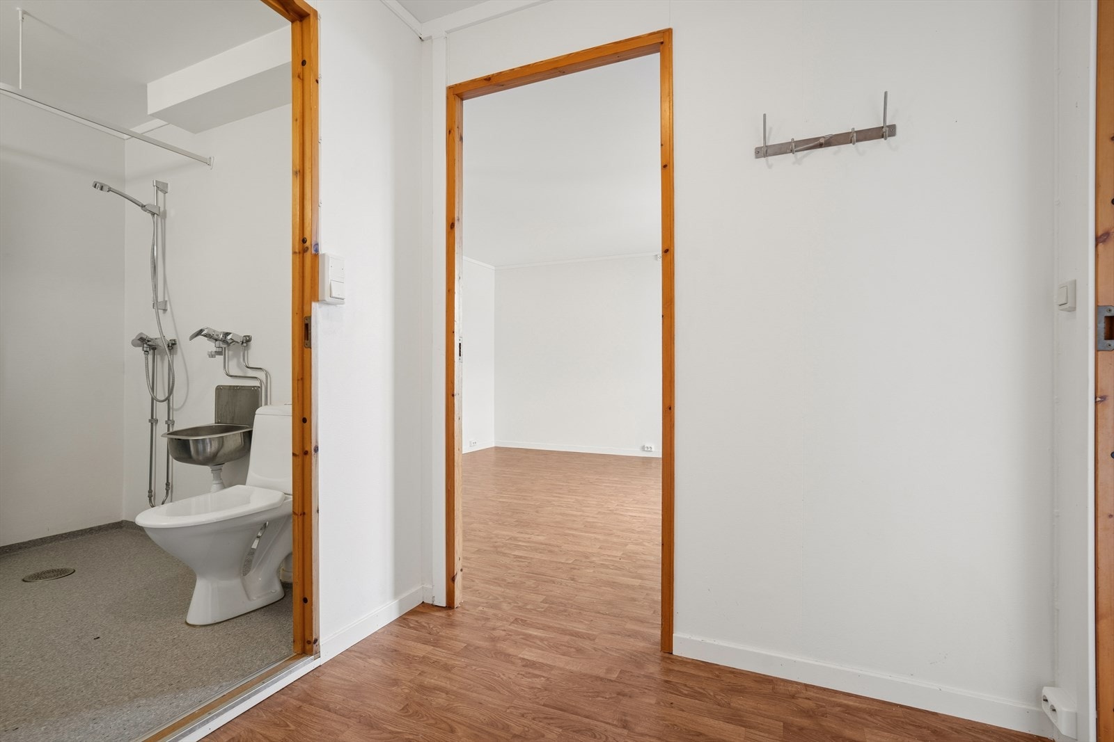 Videre inn i leiligheten møtes man av badet og en romslig stue Galleribilde