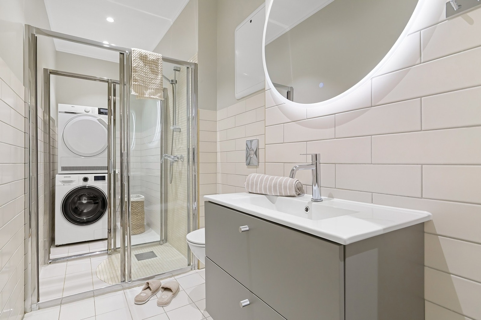 Delikat og stort baderom med varmekabler og opplegg for vaskemaskin i egen sone. Galleribilde